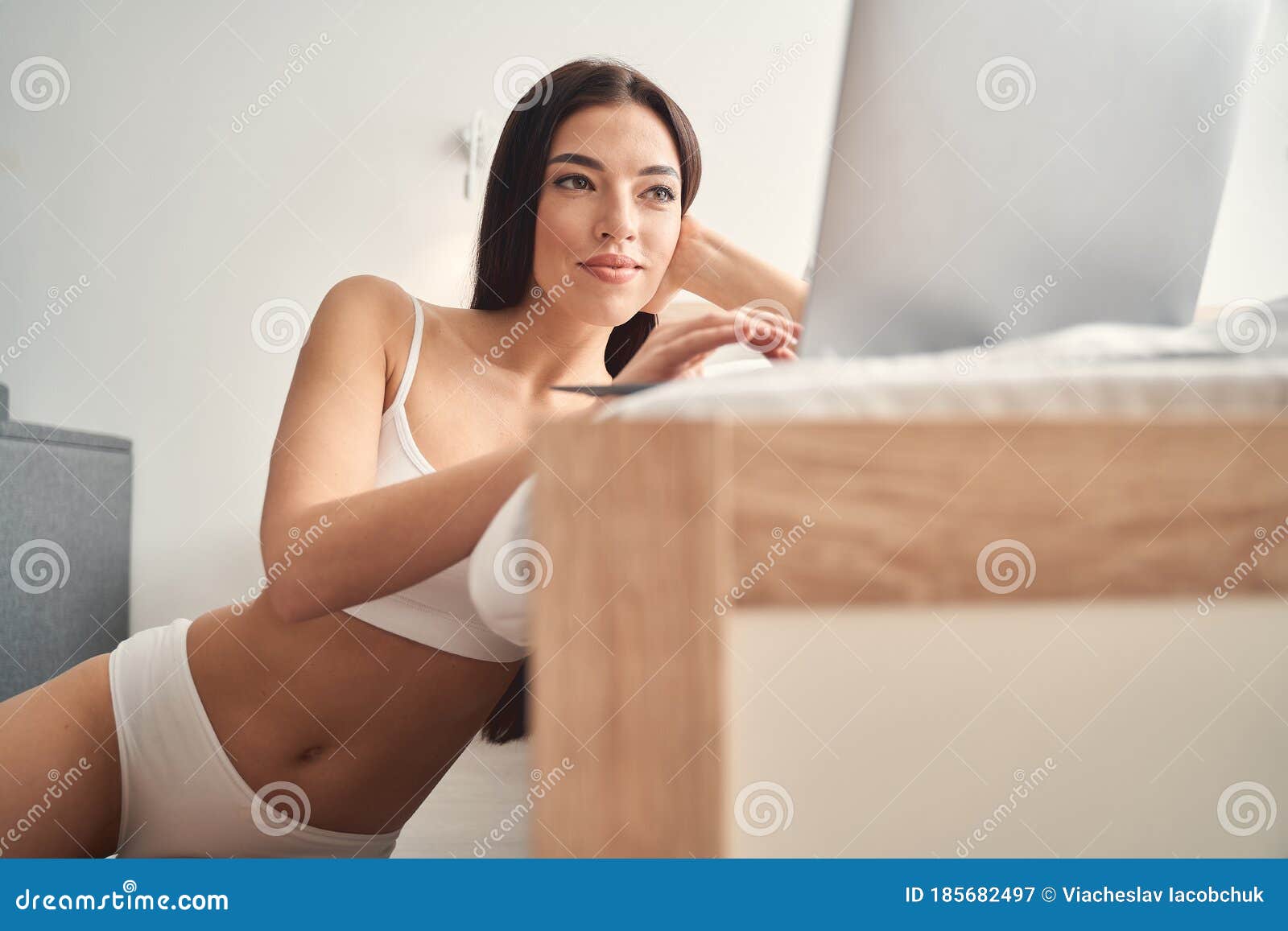 Low Angle View Of Young Woman In Bra And Underwear With Hand Over