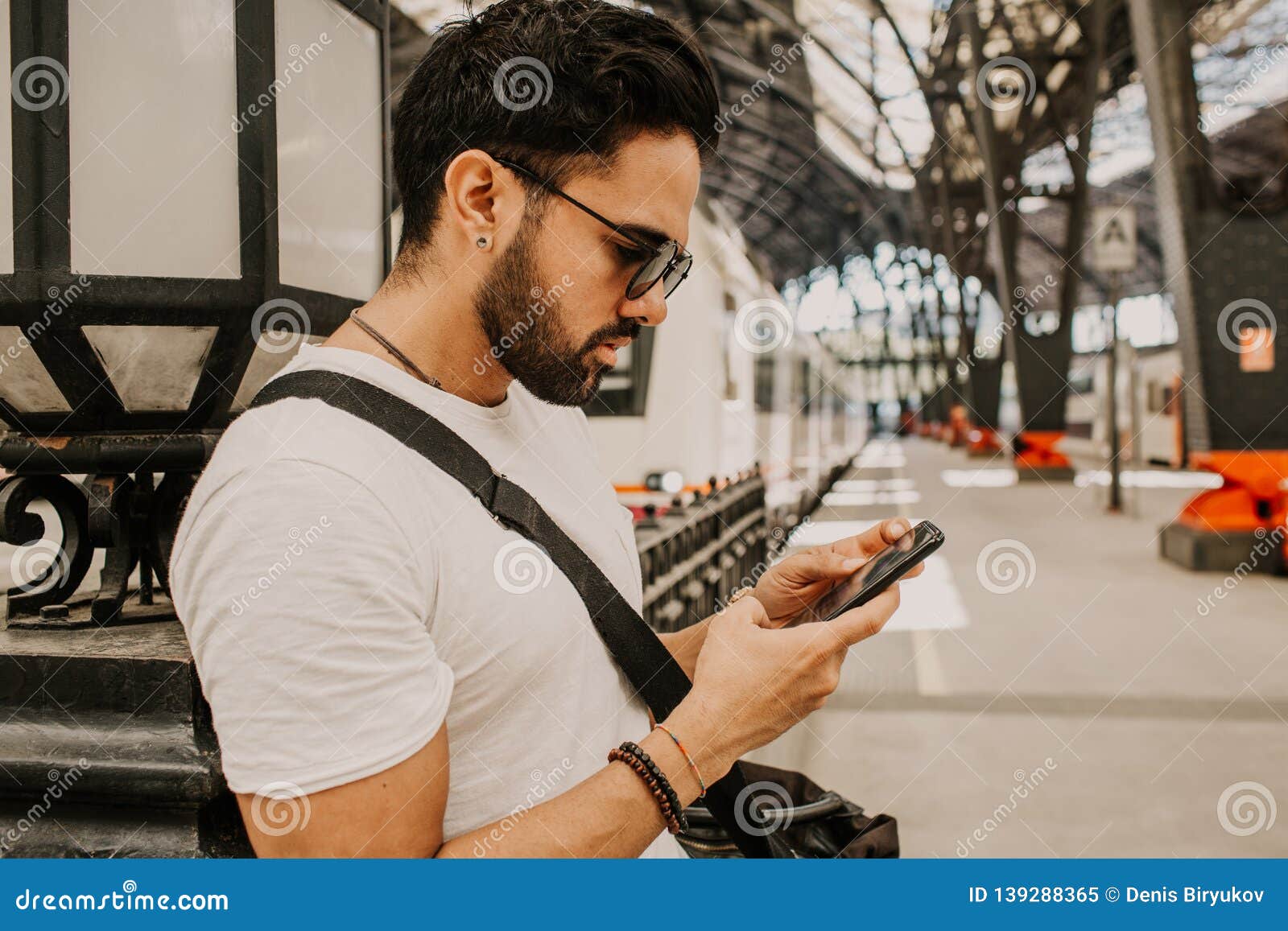 Attractive Businessman Sending Message On His Mobile  Phone 