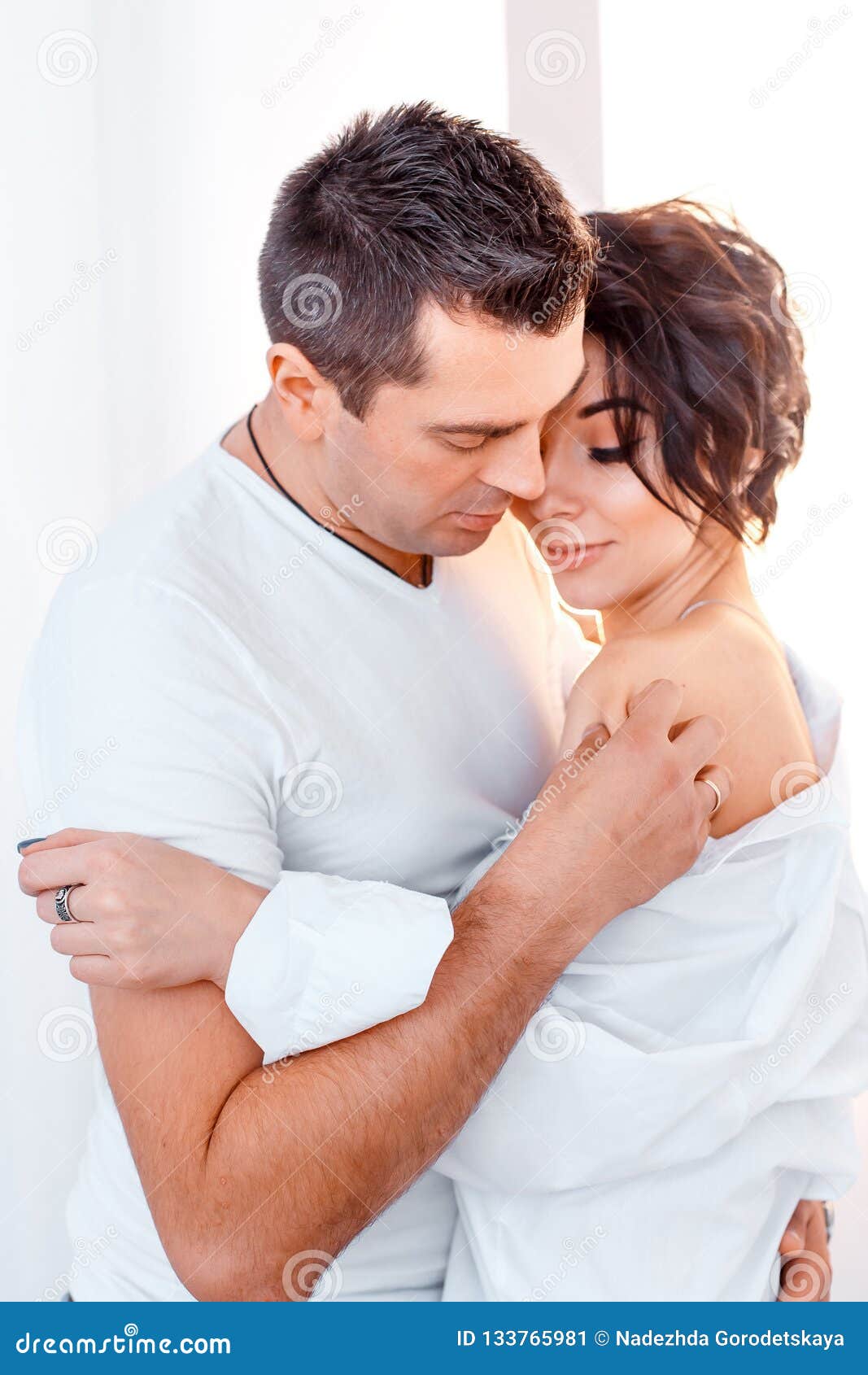 attractive cheerful man and woman hugging. couple cuddling, love and romence concept