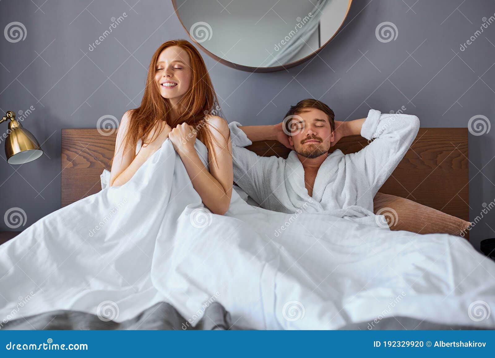Attractive Couple Lie on Bed after Sex Stock Photo