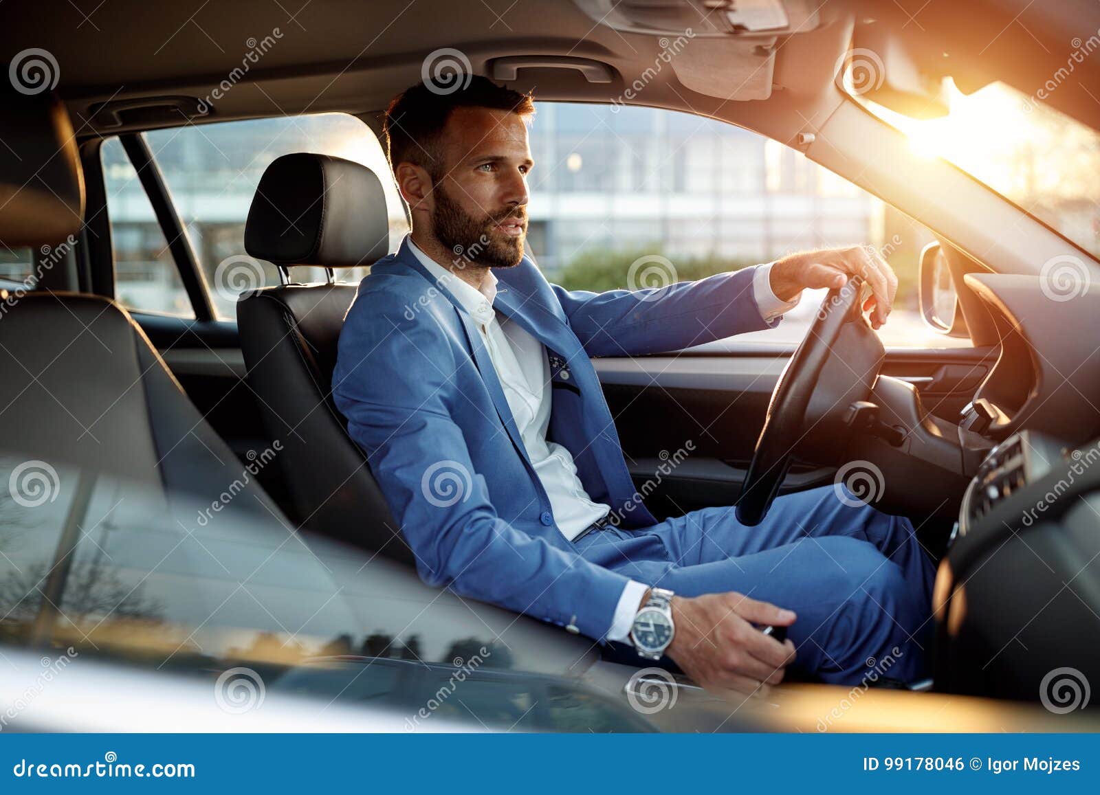 attractive man in business suit driving car