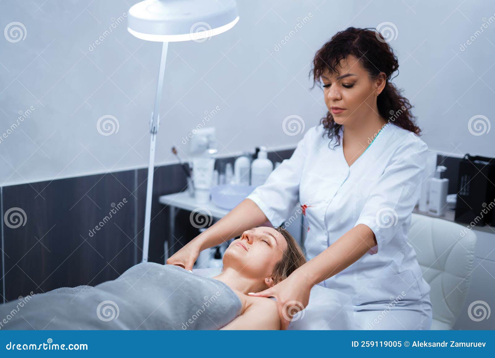 Attractive Female At Spa Health Club Getting A Facial Massage Beautician Doing Massage Of Face