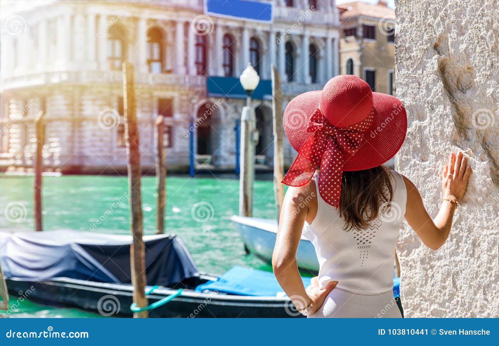 attractive female tourist at the canal grande in venice, italy