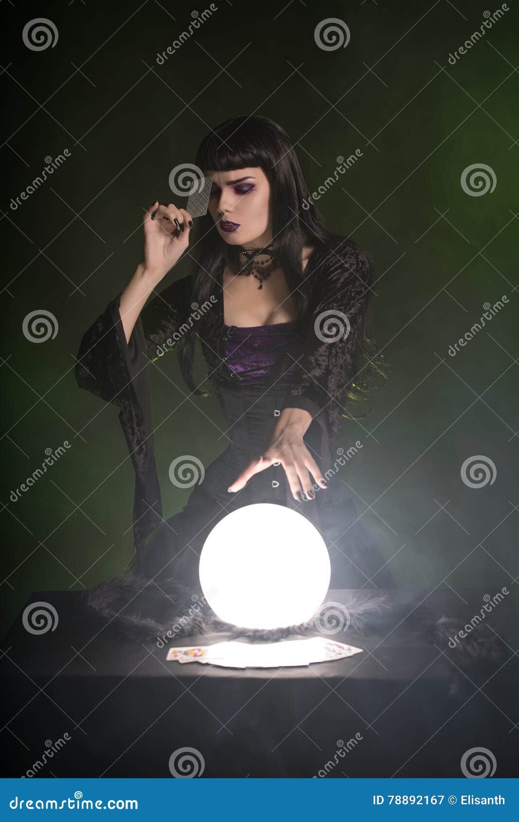 Attractive Fortune Teller with Playing Cards and Crystal Ball Stock