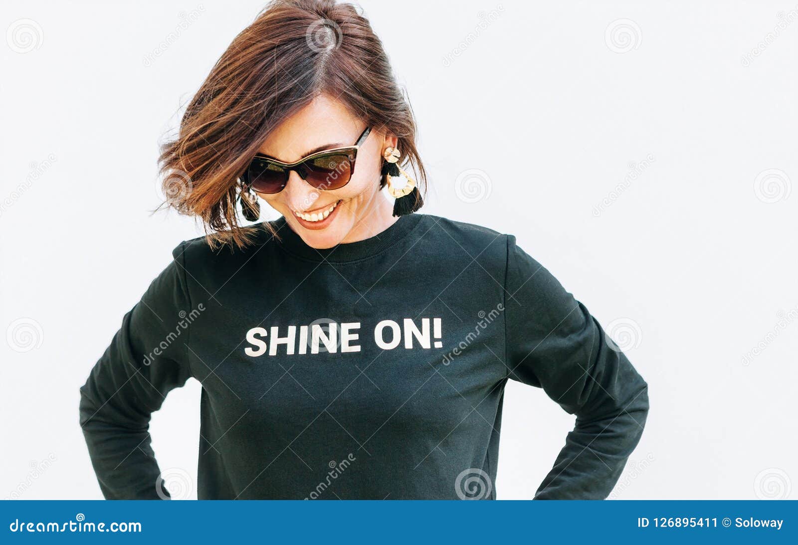 attractive free feeling smiling woman in black sweatshirt