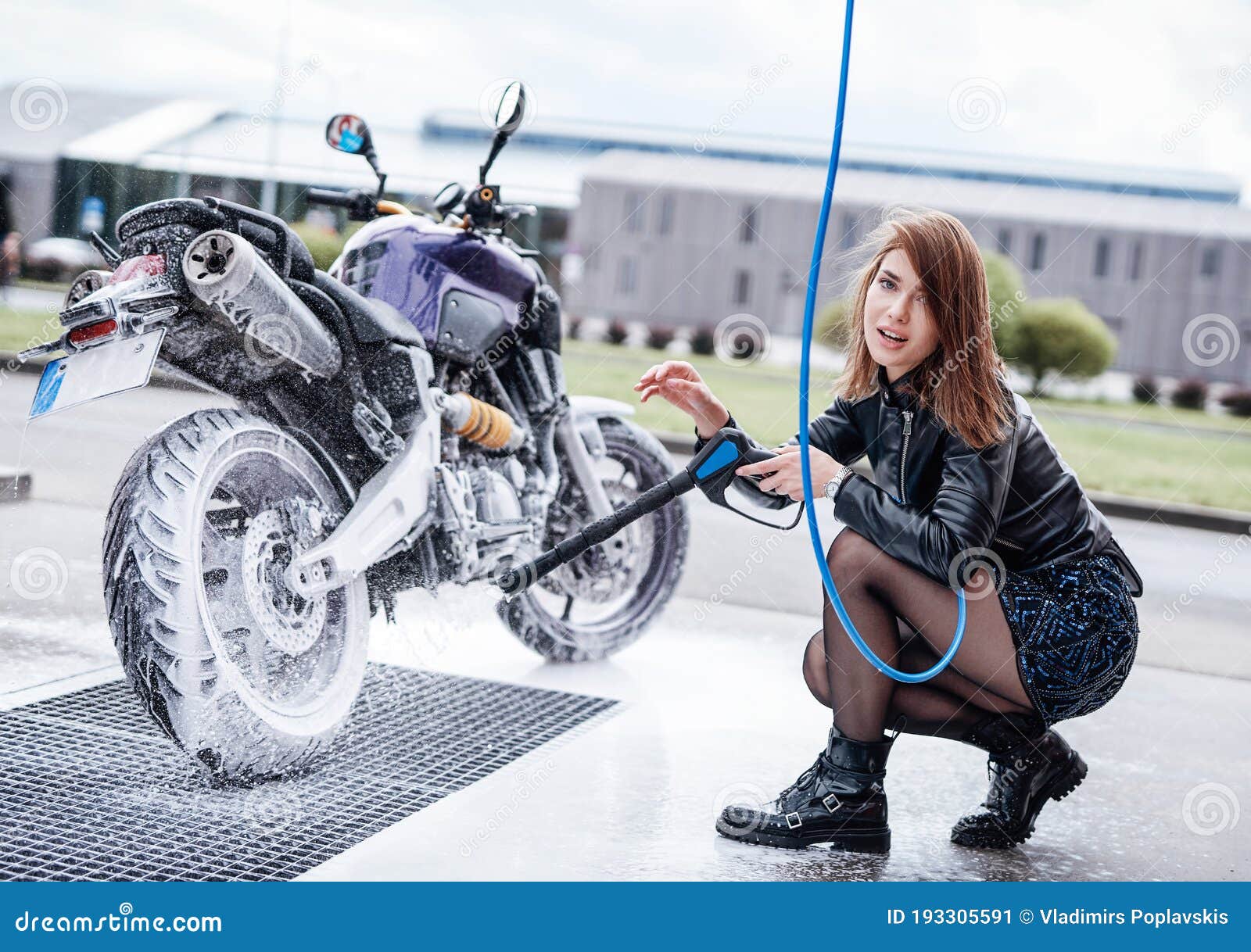 An Attractive Girl Washing Her Motorcycle In Service Stock Image