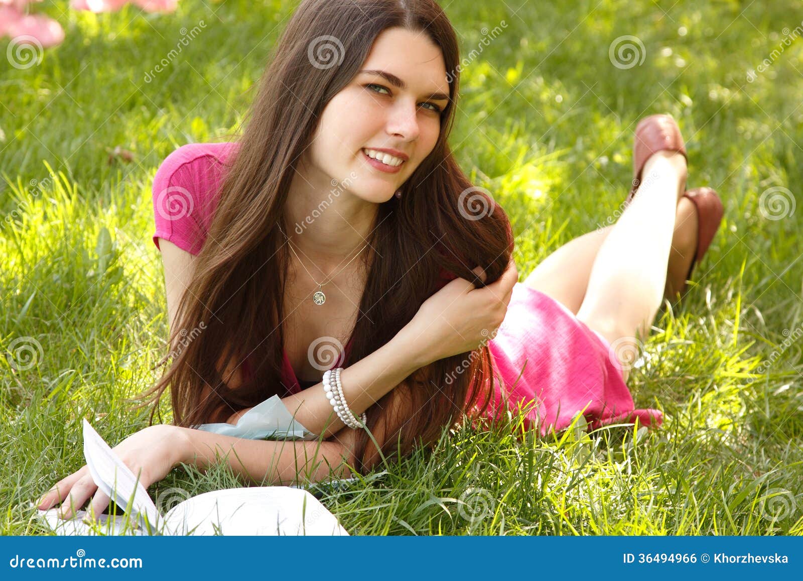 Attractive Happy Smiling Student Teen Girl Reading Book on Green Stock ...