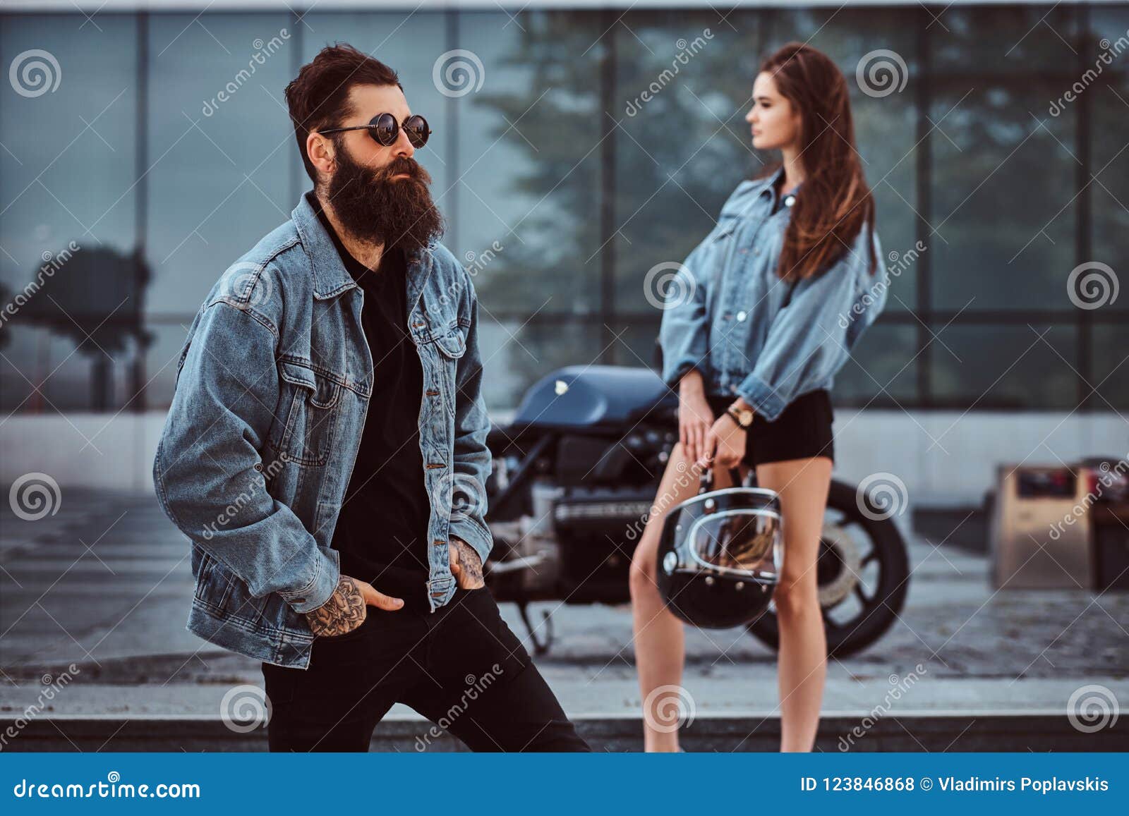 Attractive Hipster Couple Bearded Brutal Male In Sunglasses Dressed In A Jeans Jacket And His