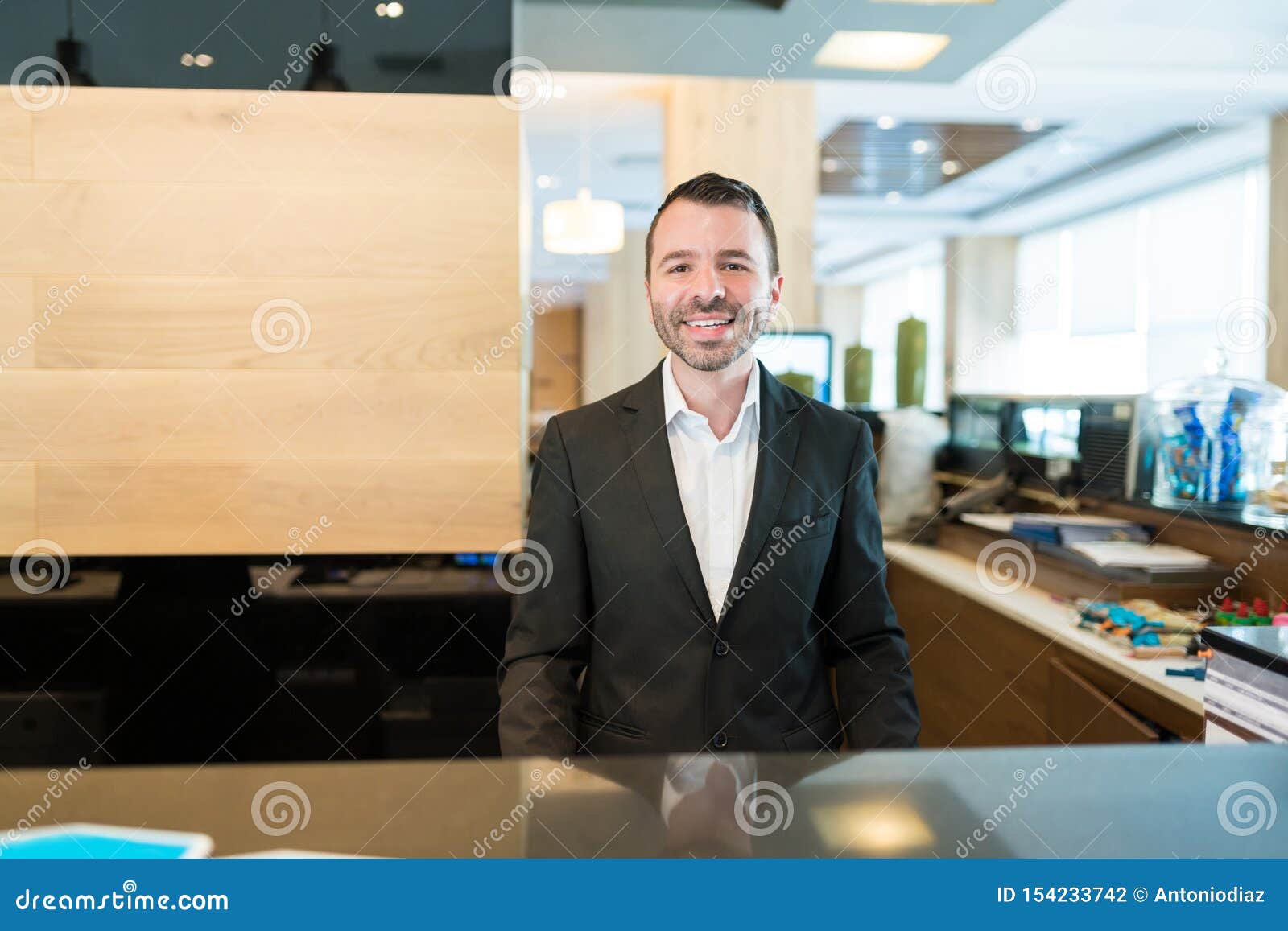 Attractive Hotel Clerk Smiling At Front Desk Stock Photo Image