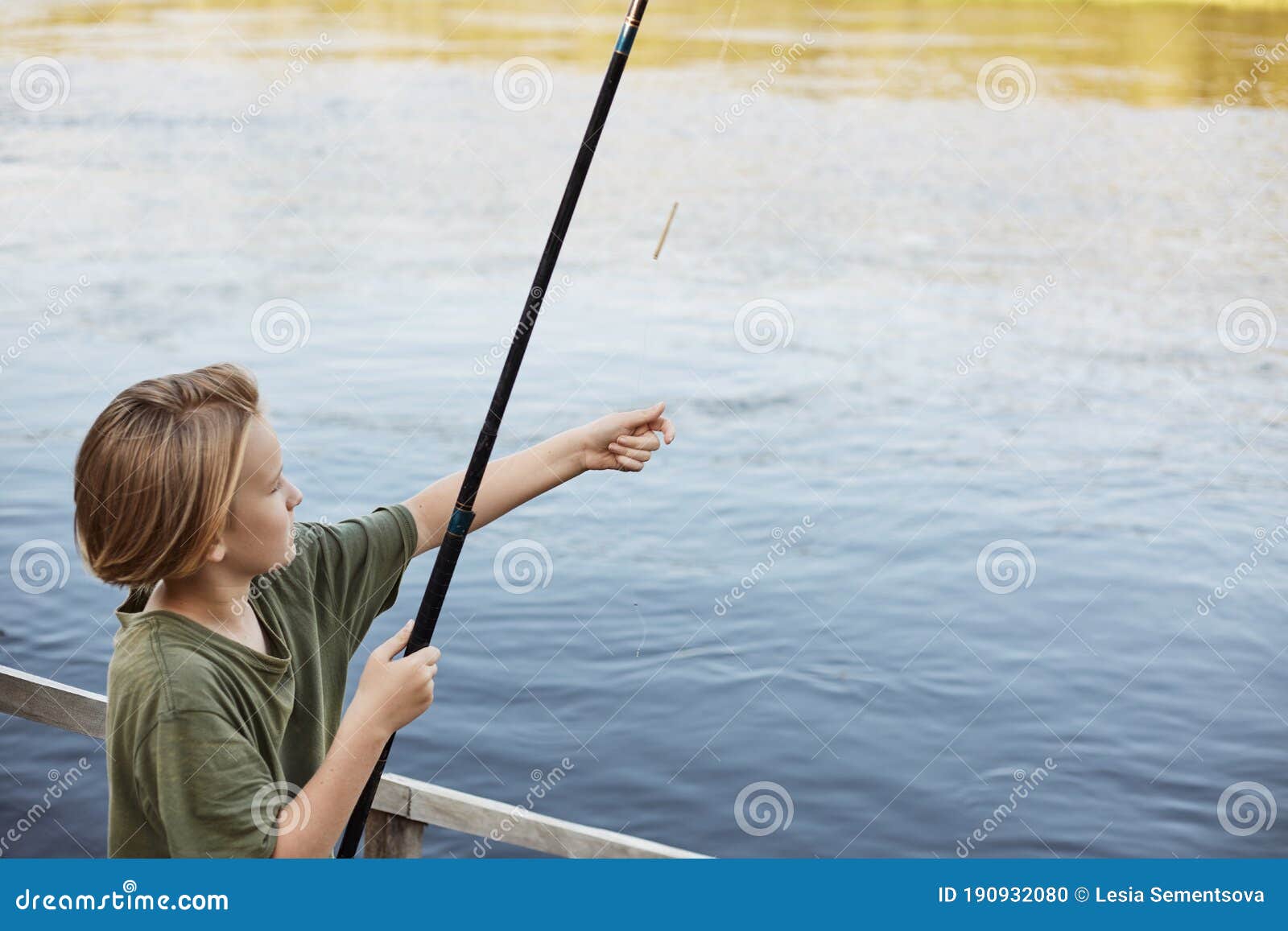 Attractive Little Guy Casting Fishing Rod To River, Wants To Catch