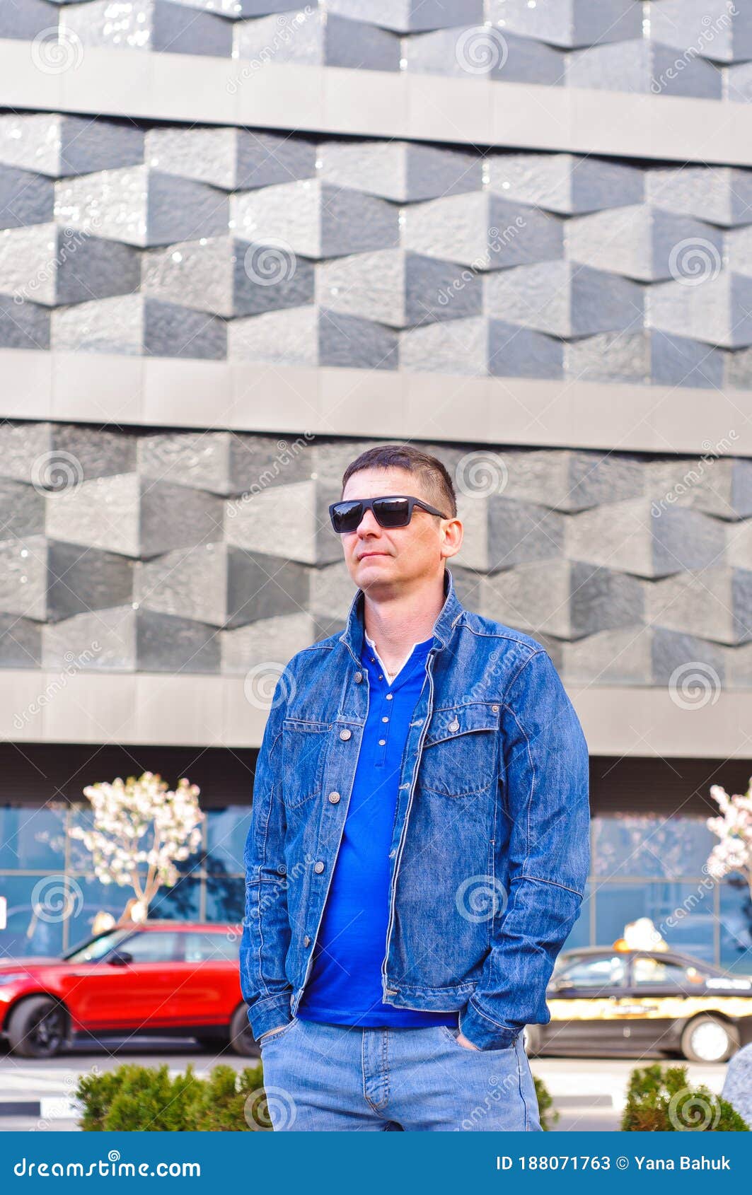 attractive man with sunglasses and a suit case