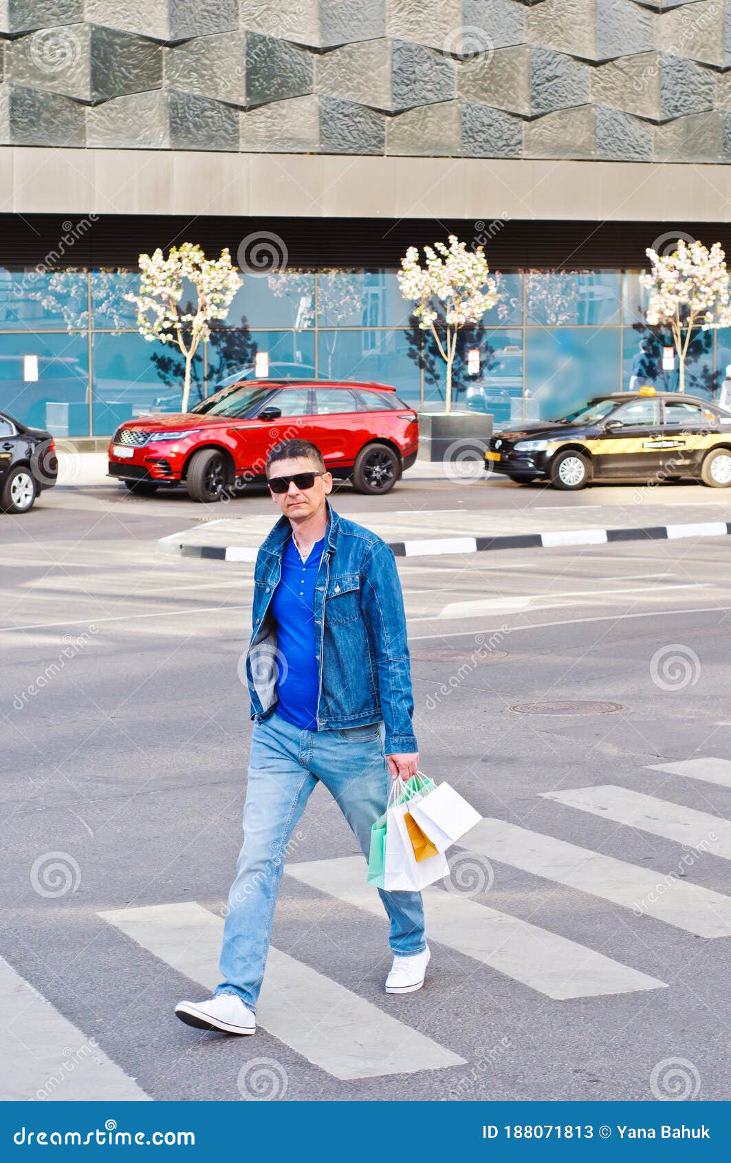 attractive man with sunglasses and a suit case