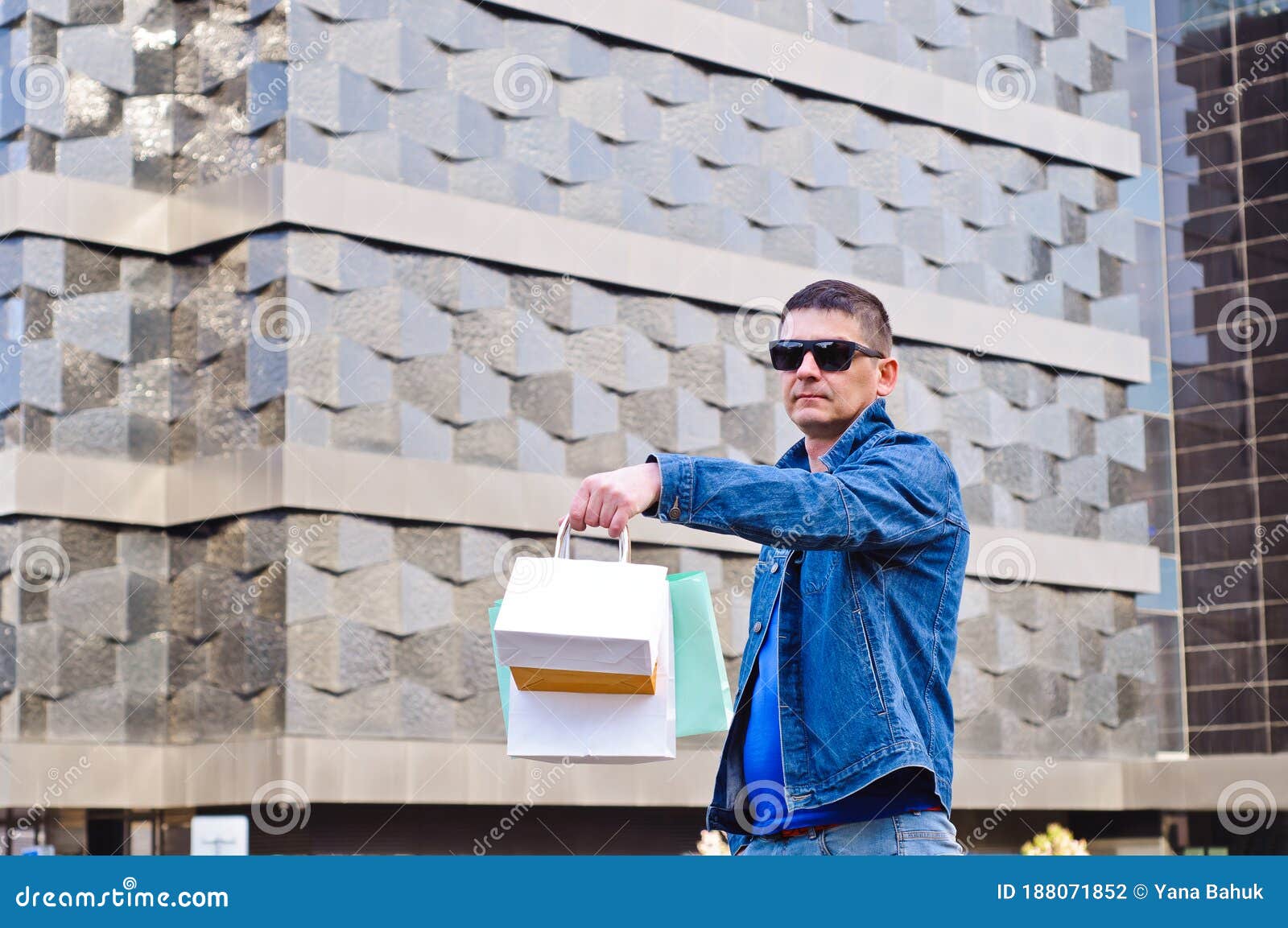 attractive man with sunglasses and a suit case