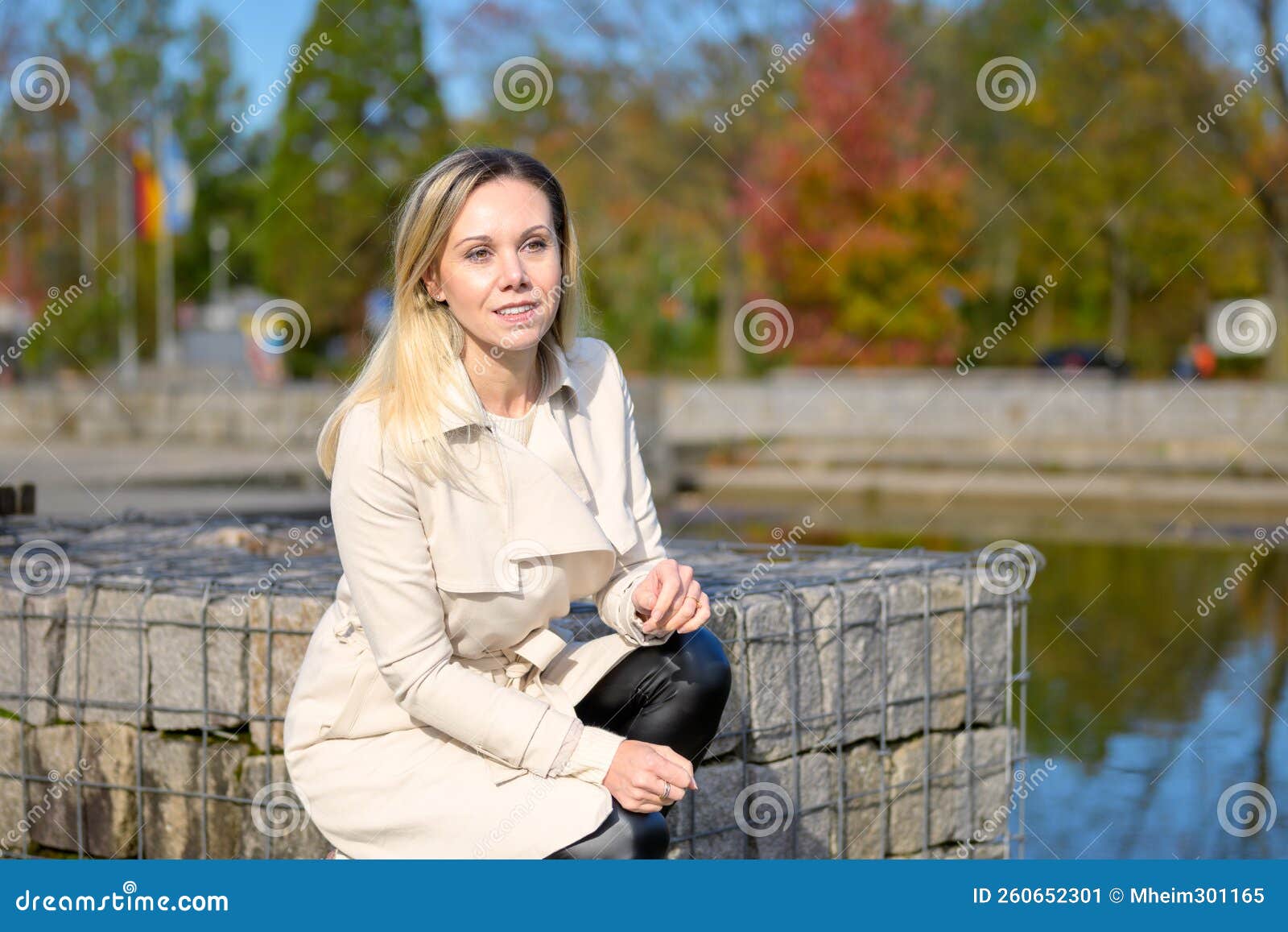 Woman Kneeling By A Lake Stock Image Image Of Fall 260652301