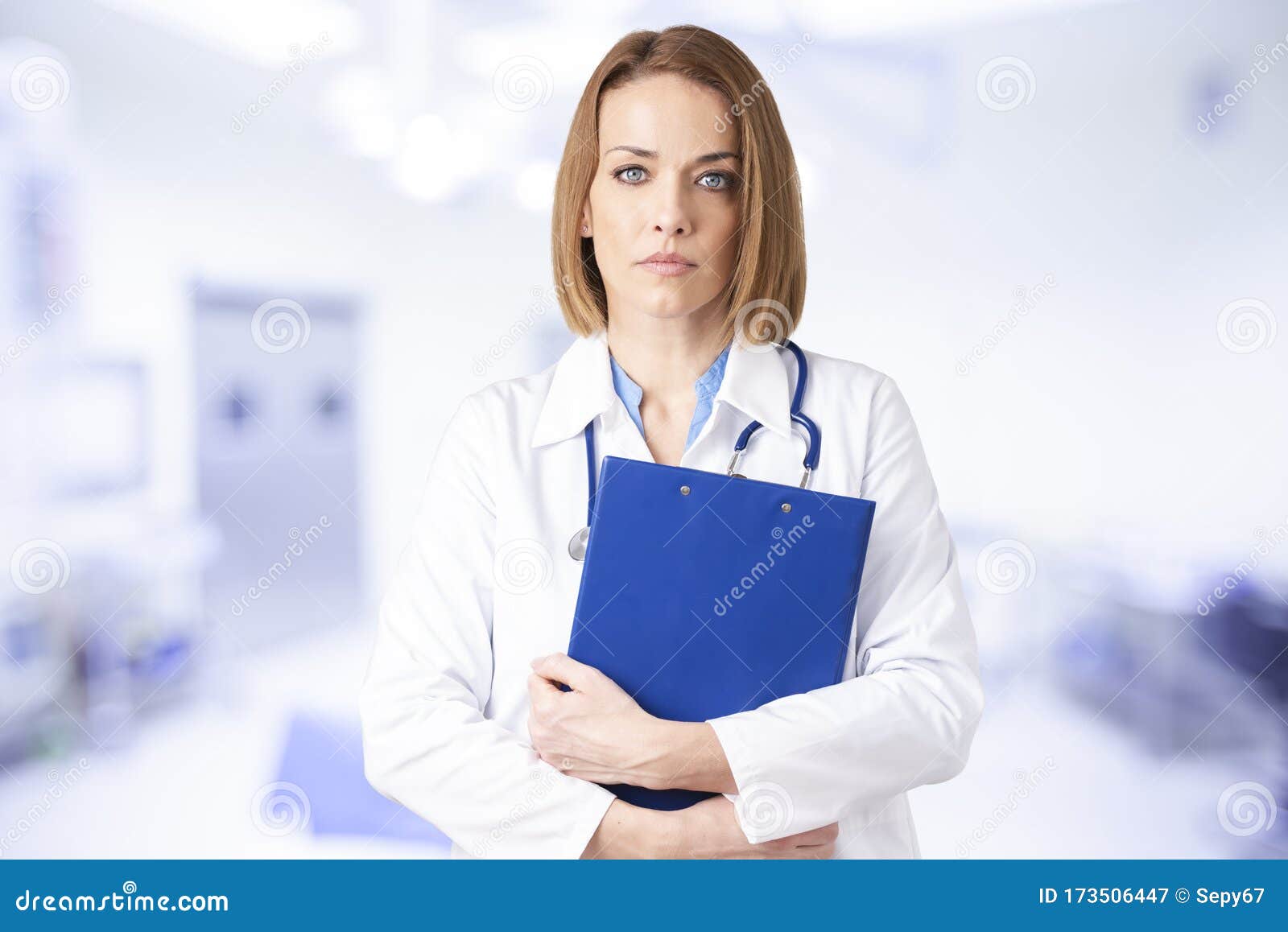 attractive middle aged female doctor standing in doctor`s room
