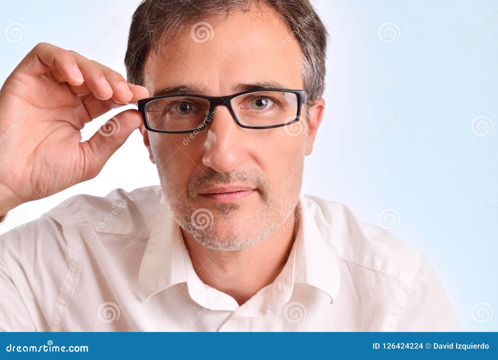 Attractive Middle-aged Man Adjusting the Glasses Staring Stock Photo ...