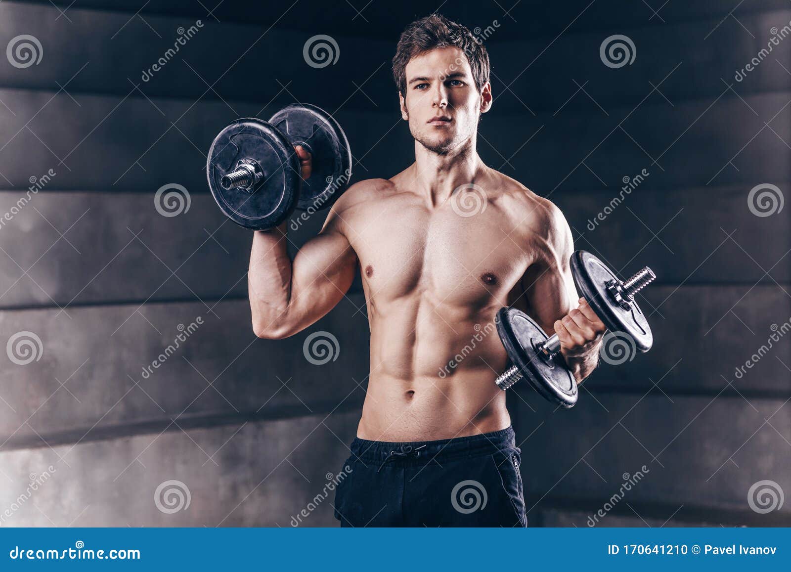 Athletic Man Showing Muscular Body And Doing Exercises 