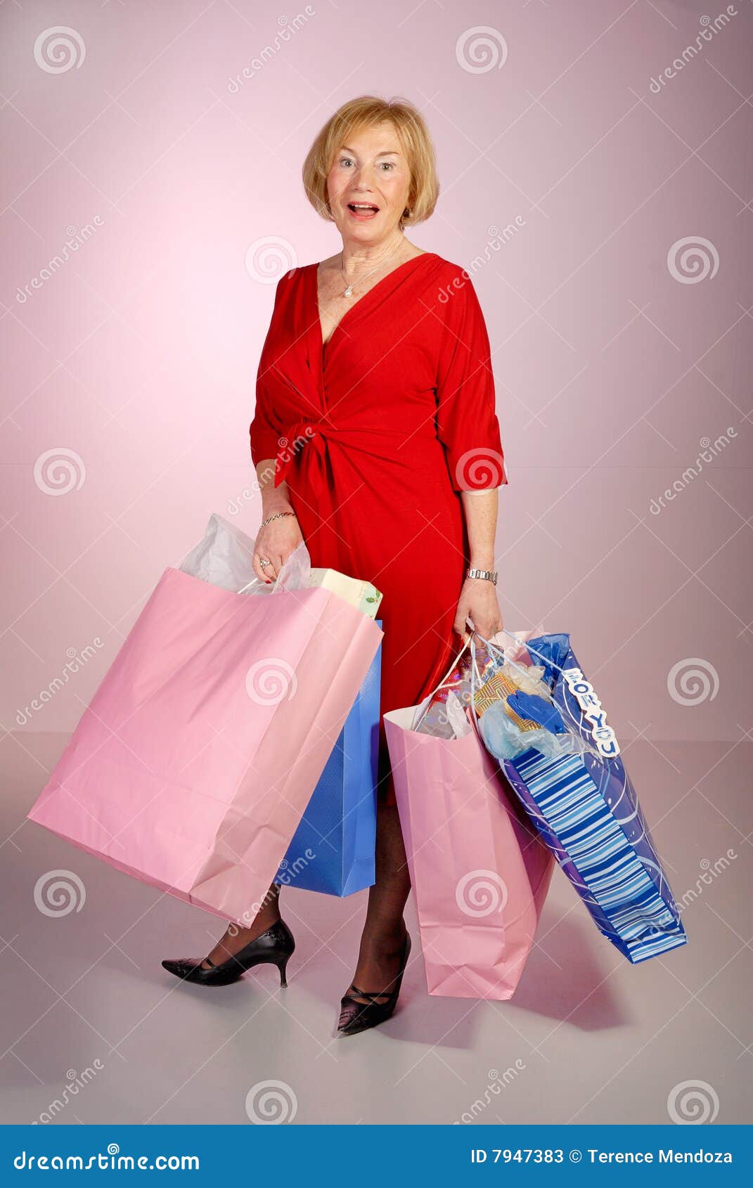 Attractive Older Lady Holding Shopping Bags Stock Image - Image of ...