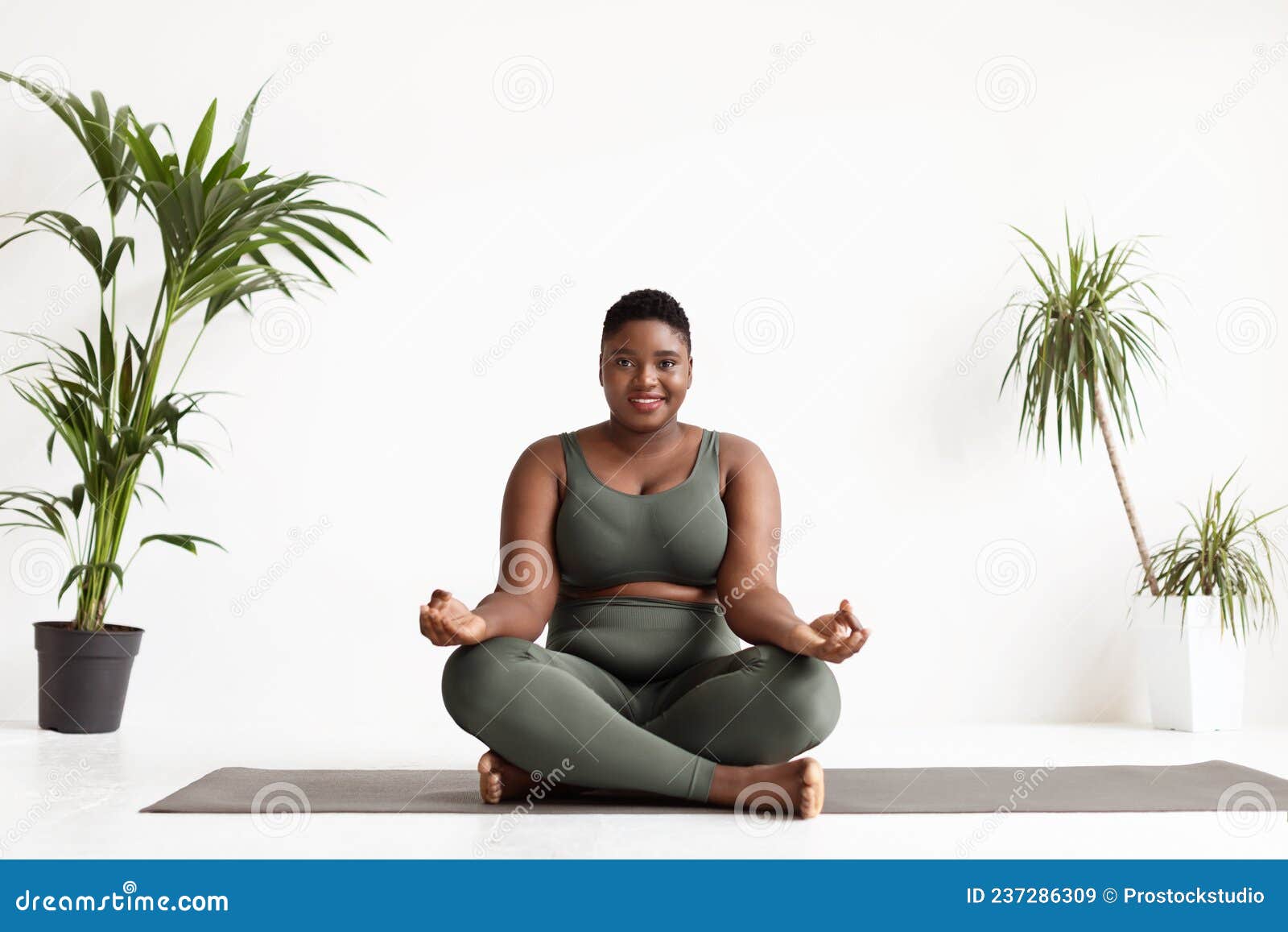 Attractive Plus Size Black Woman Doing Yoga Exercise at Studio