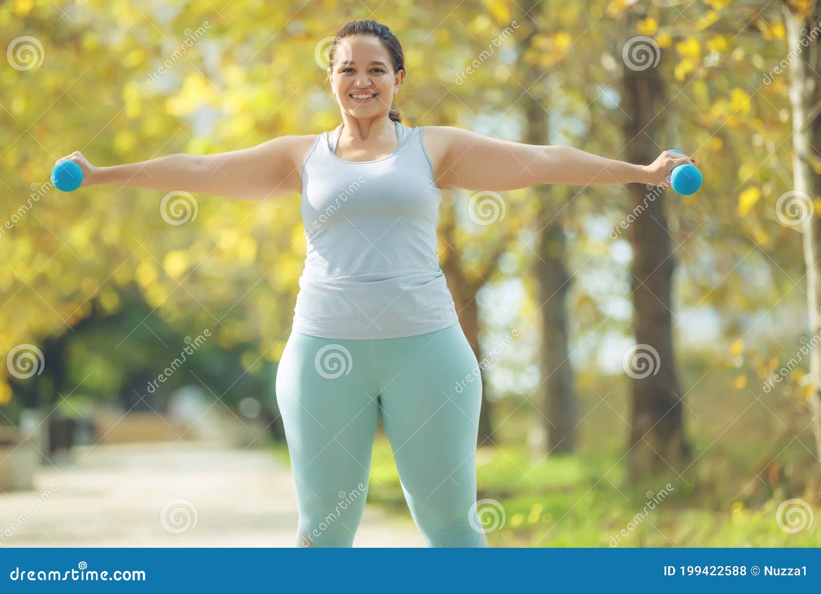 An Attractive Plus Size Woman in a Sports Top and Leggings, Goes