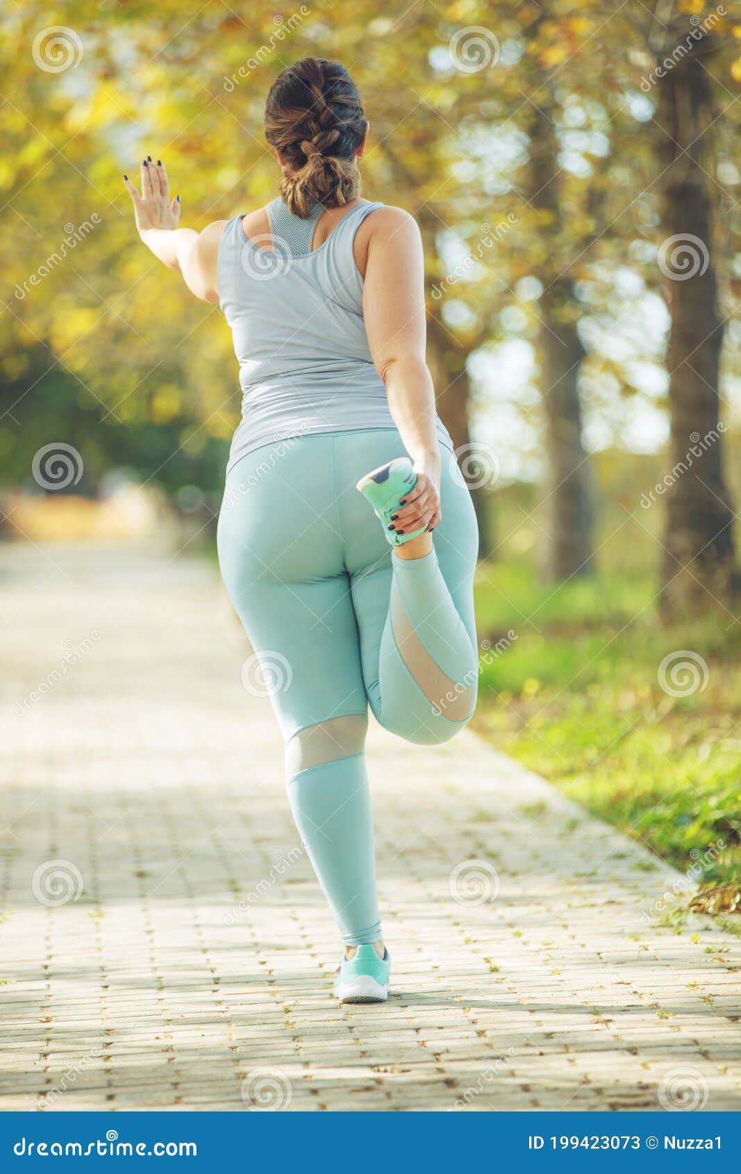 An Attractive Plus Size Woman in a Sports Top and Leggings, Goes in for  Sports, Works Out in a Cozy City Park. Stock Image - Image of people,  mother: 199423073