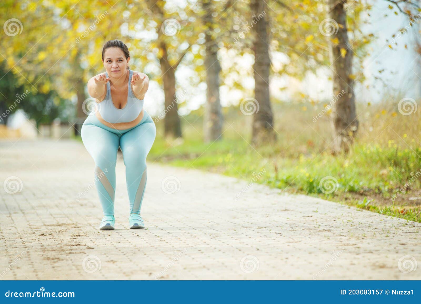 An Attractive Plus Size Woman in a Sports Top and Leggings, Goes in for  Sports, Works Out in a Cozy City Park. Stock Image - Image of plump,  looking: 203083157