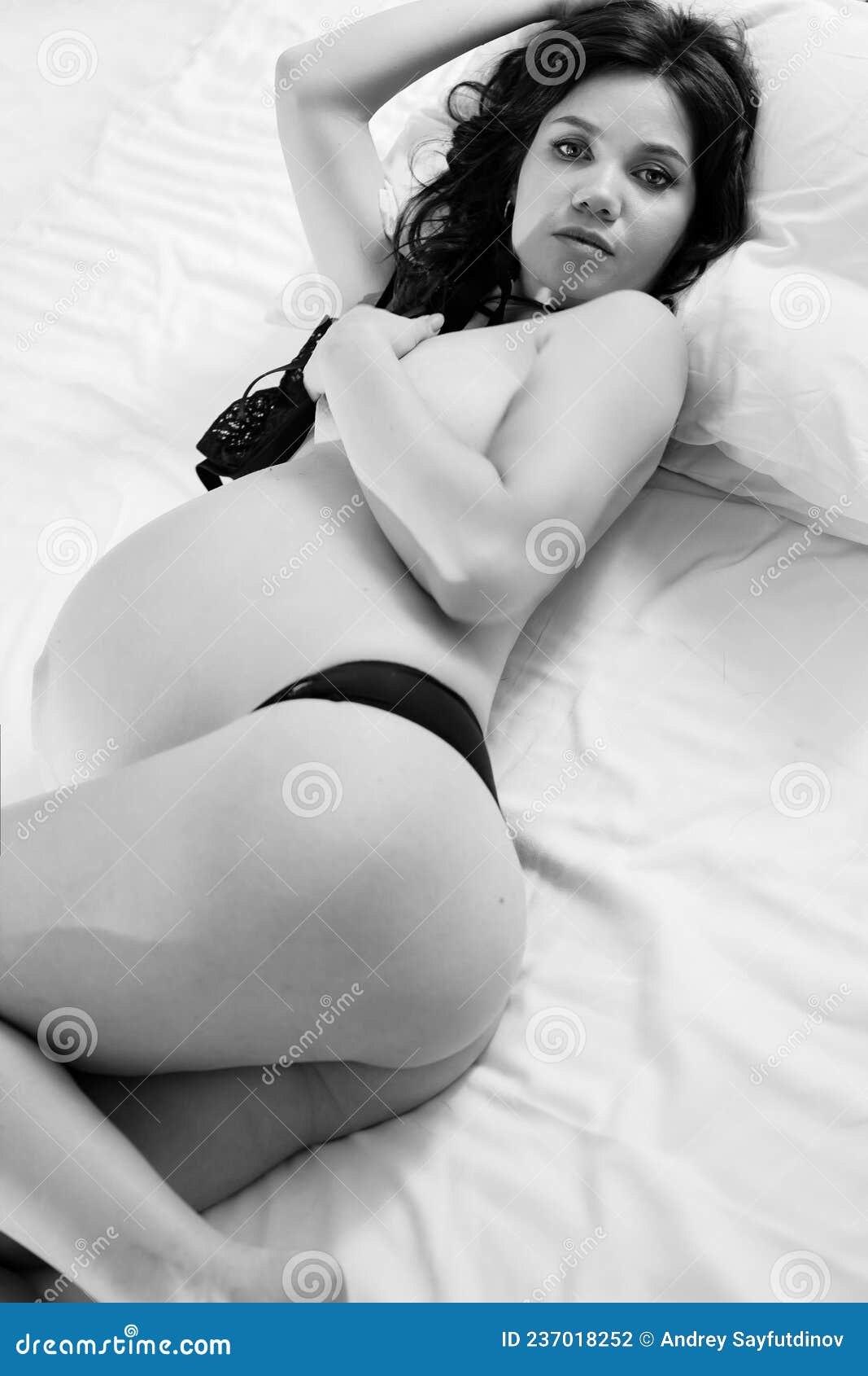 Attractive Pregnant Woman in Bed in Underwear