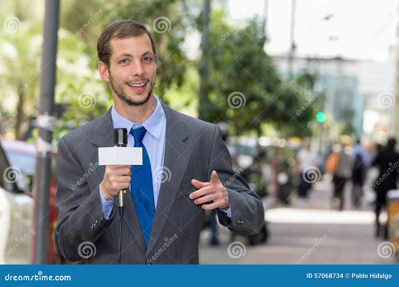 attractive professional male news reporter wearing