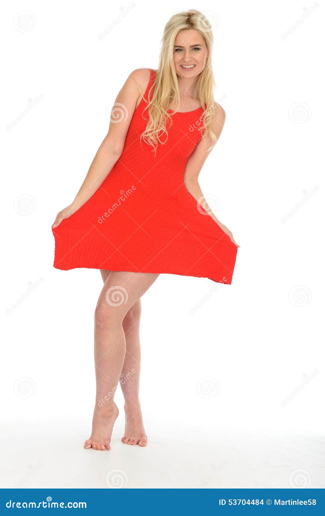 Young Blond Woman In Mini Dress Sitting On A Chair Stock 