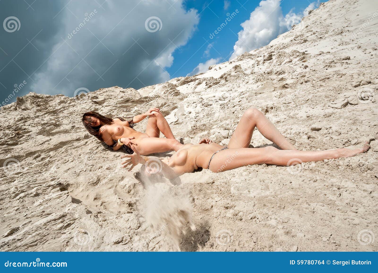 Appealing naked babes are relaxing on the beach