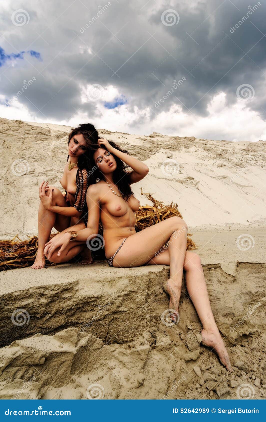 Appealing naked babes are relaxing on the beach