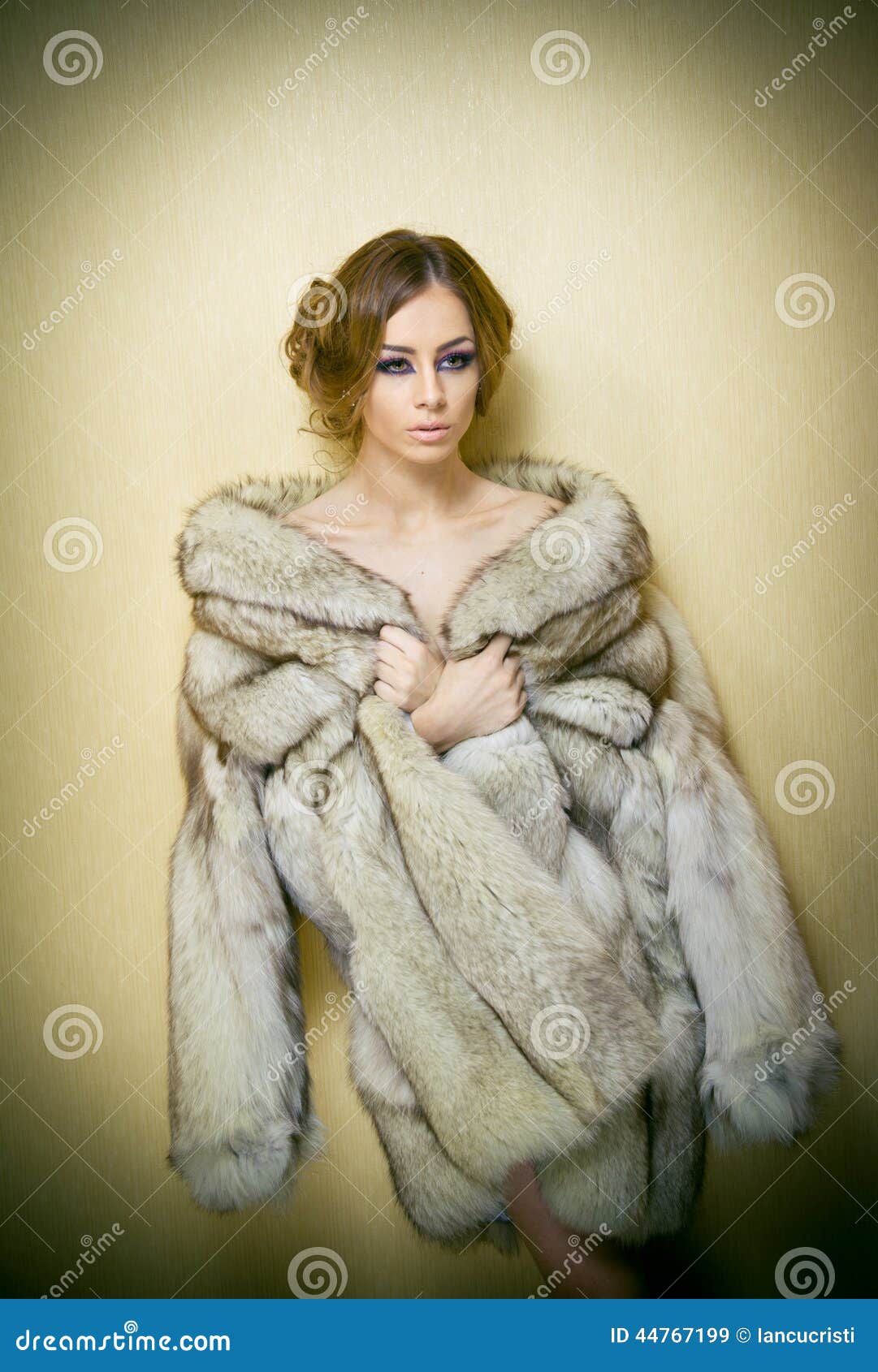 Attractive Young Woman Wearing a Fur Coat Posing Provocatively Indoor ...