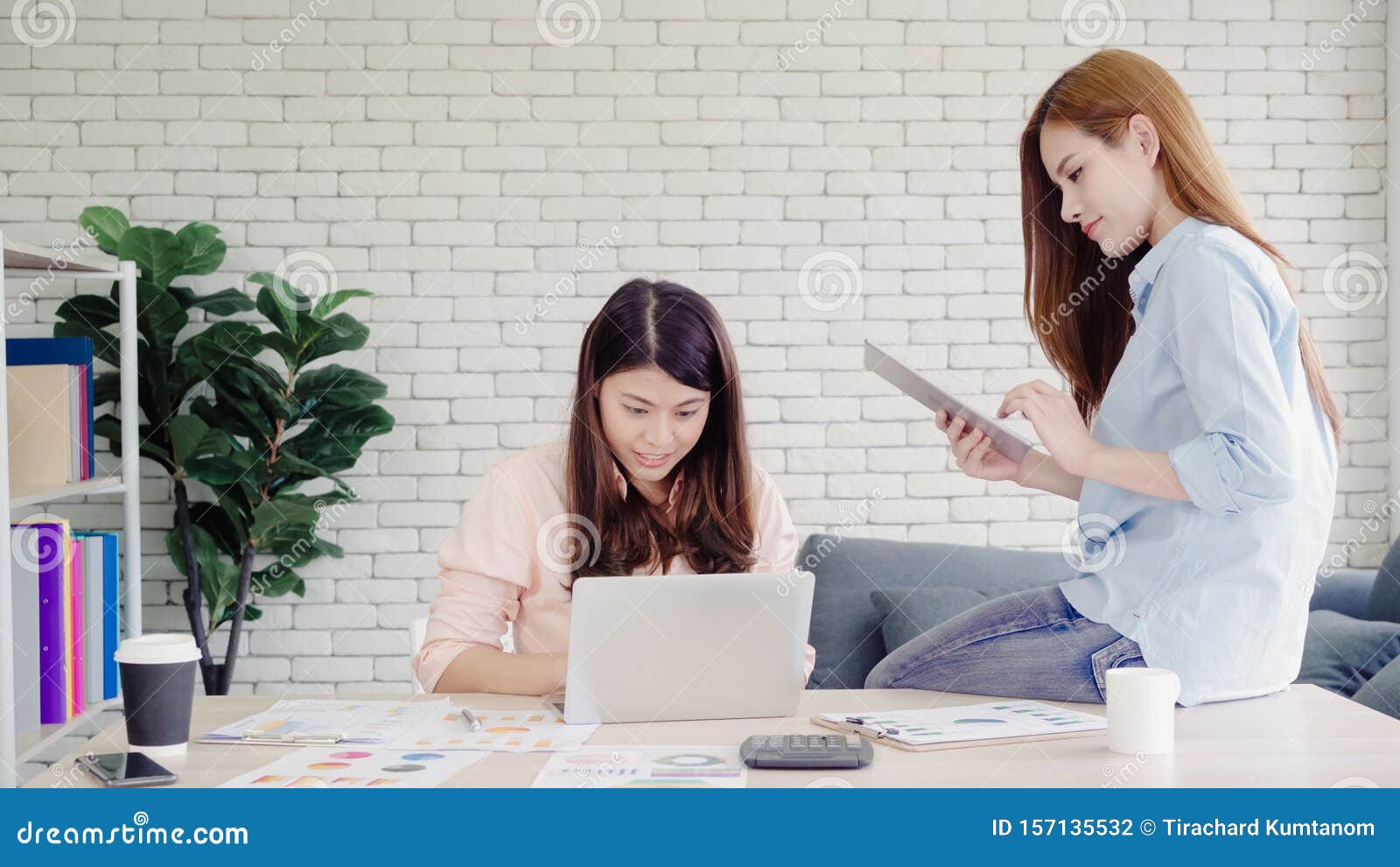 Attractive Smart Creative Asian Business Women in Smart Casual Wear Working  on Laptop while Sitting on Desk on Office Desk. Women Stock Photo - Image  of asia, conversation: 157135532