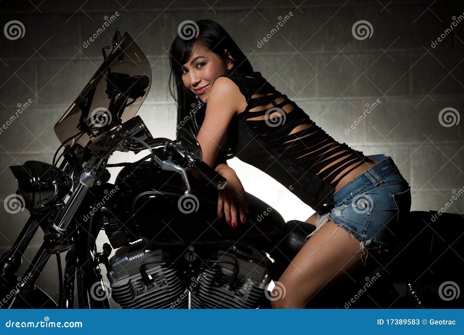 attractive thirties asian woman riding motorcycle
