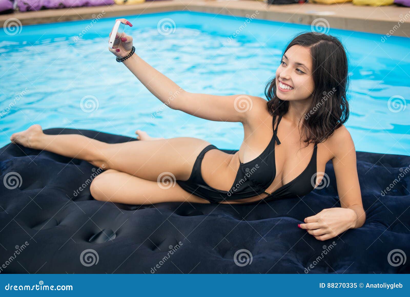 Attractive Woman in Bikini Smiling and Taking Selfie Photo on the Phone on  a Mattress in the Pool at the Resort Stock Image - Image of brunette,  female: 88270335