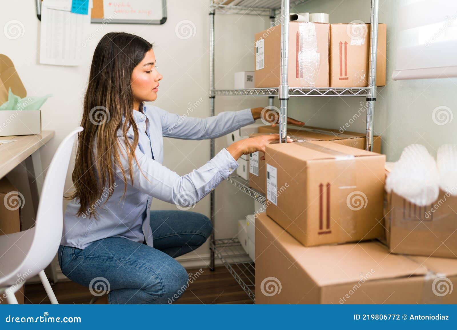 female entrepreneur preparing to ship packages
