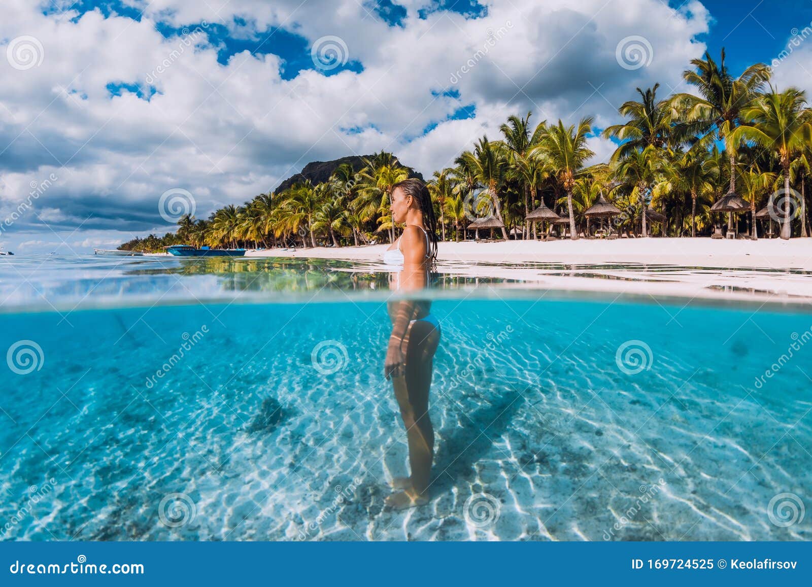 Woman Posing In Transparent Blue Ocean Swimming In Blue Water At