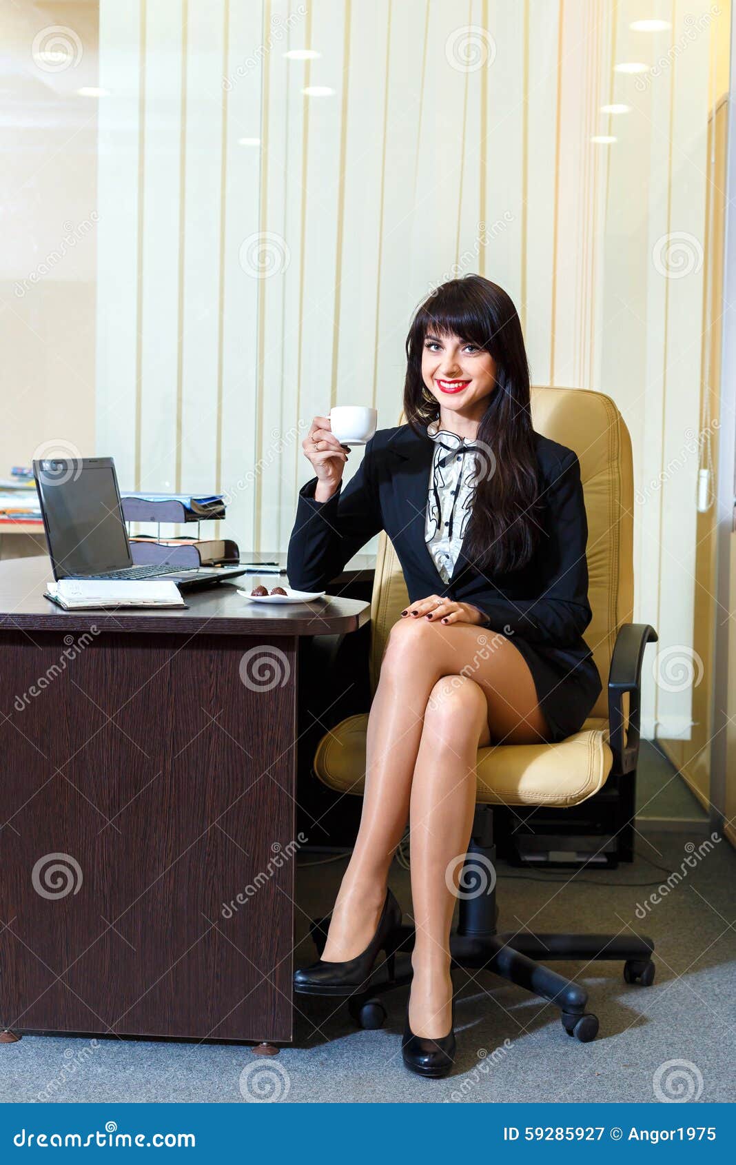 Attractive Woman In A Short Skirt Drinking Coffee Stock