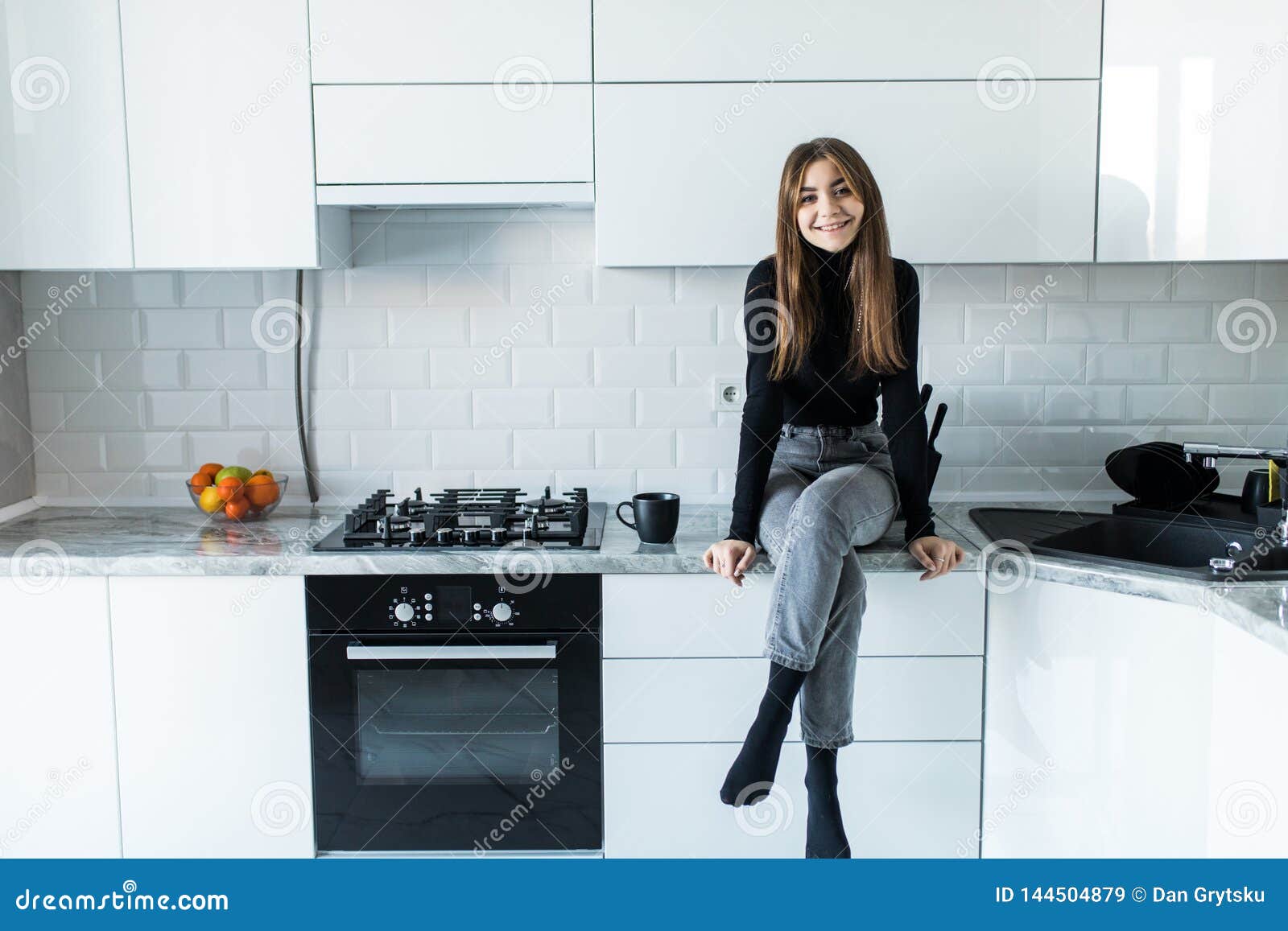 woman sitting at kitchen table dark