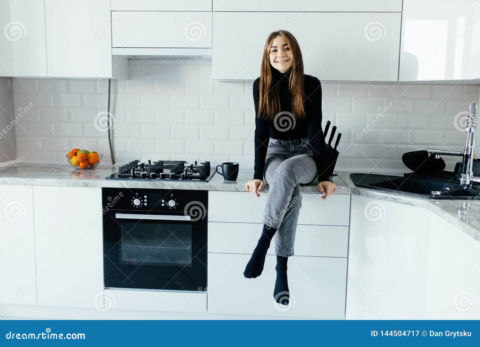 Attractive Woman Sitting On Kitchen Counter Young Housewife Relaxing