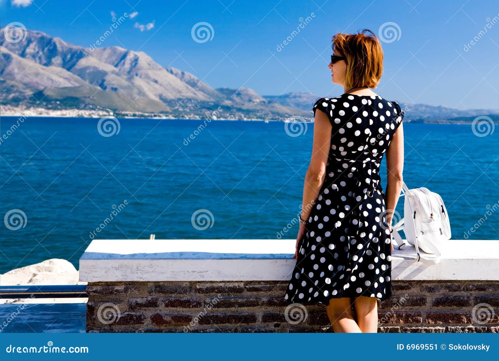 attractive woman standing on the gaeta sea coast