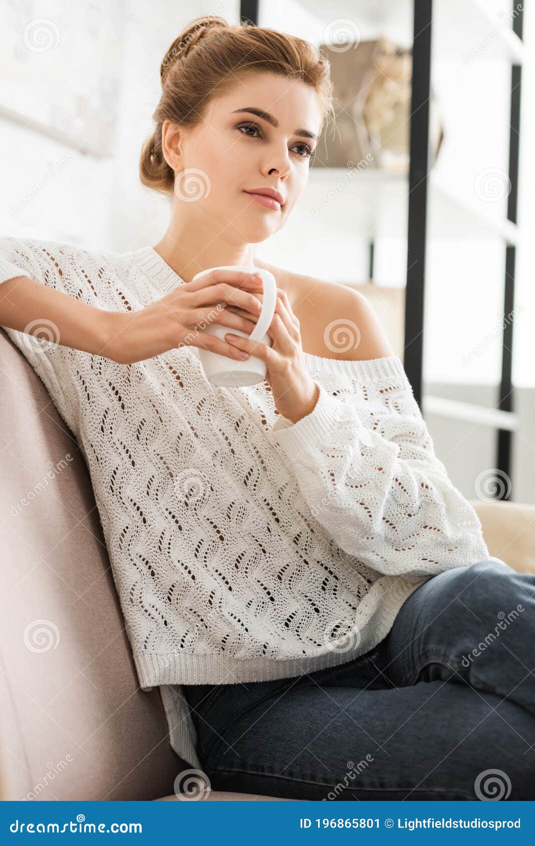 Woman In White Sweater Holding Cap And Looking Away Stock Image Image