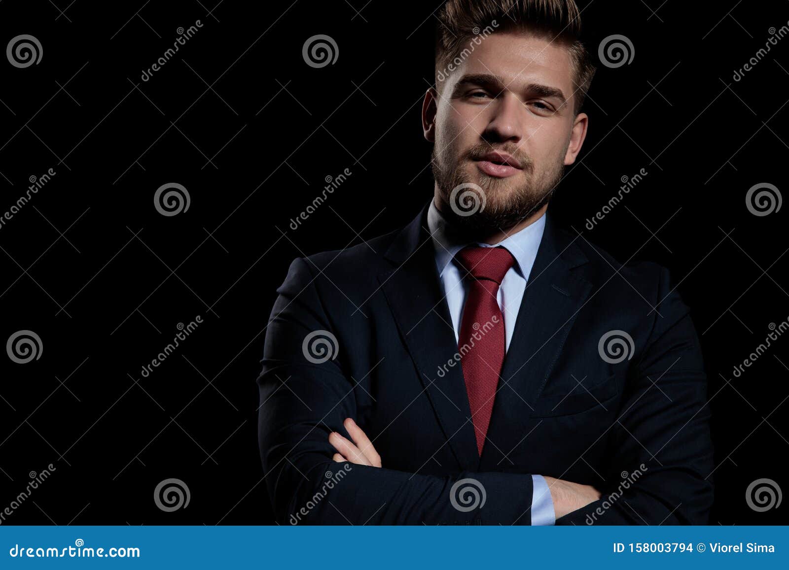 Attractive Young Businessman Folding Arms on Black Background Stock ...