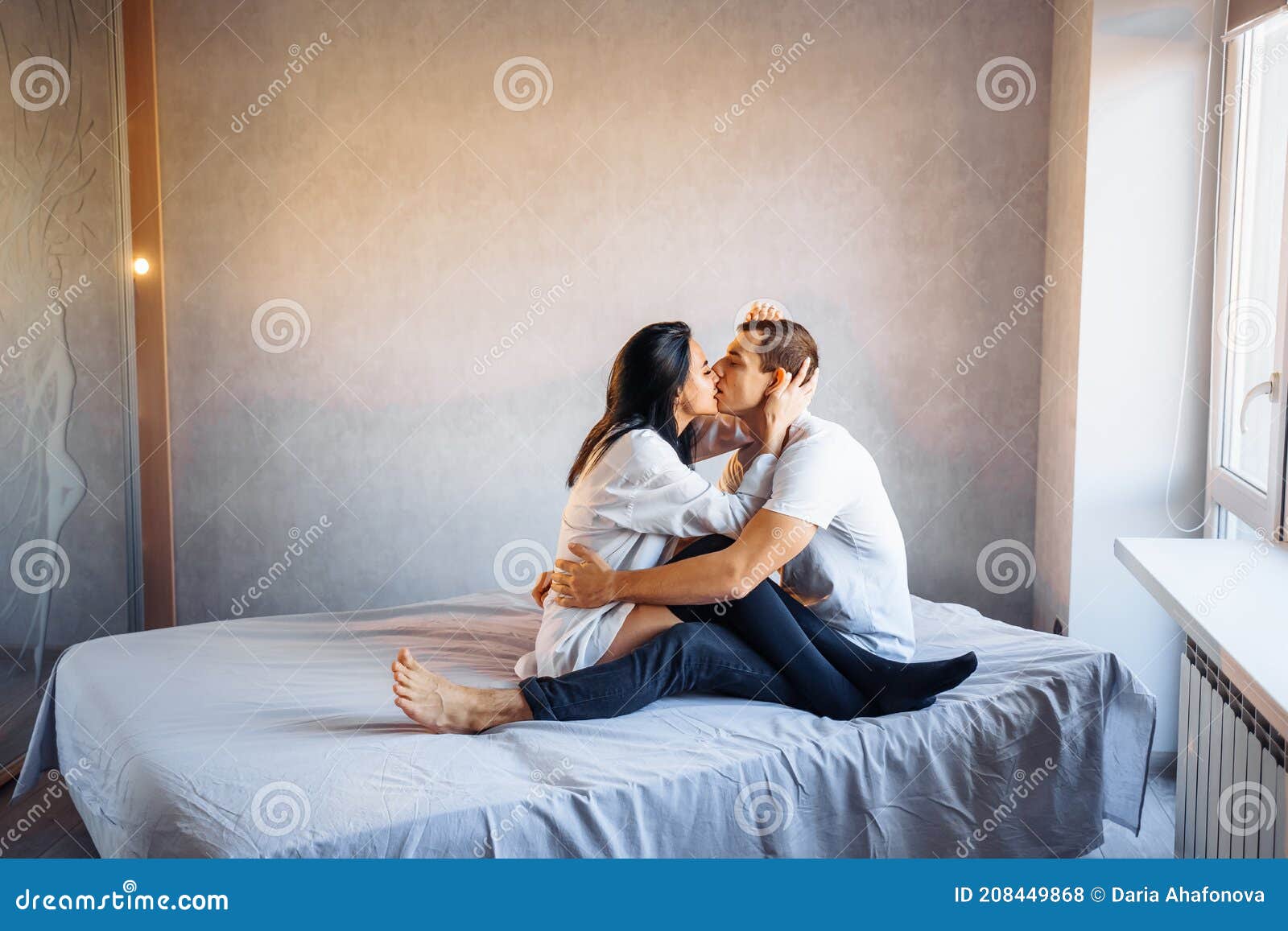 Attractive, Young Couple of Lovers Having Sex at Home in the Bed in Bright Room