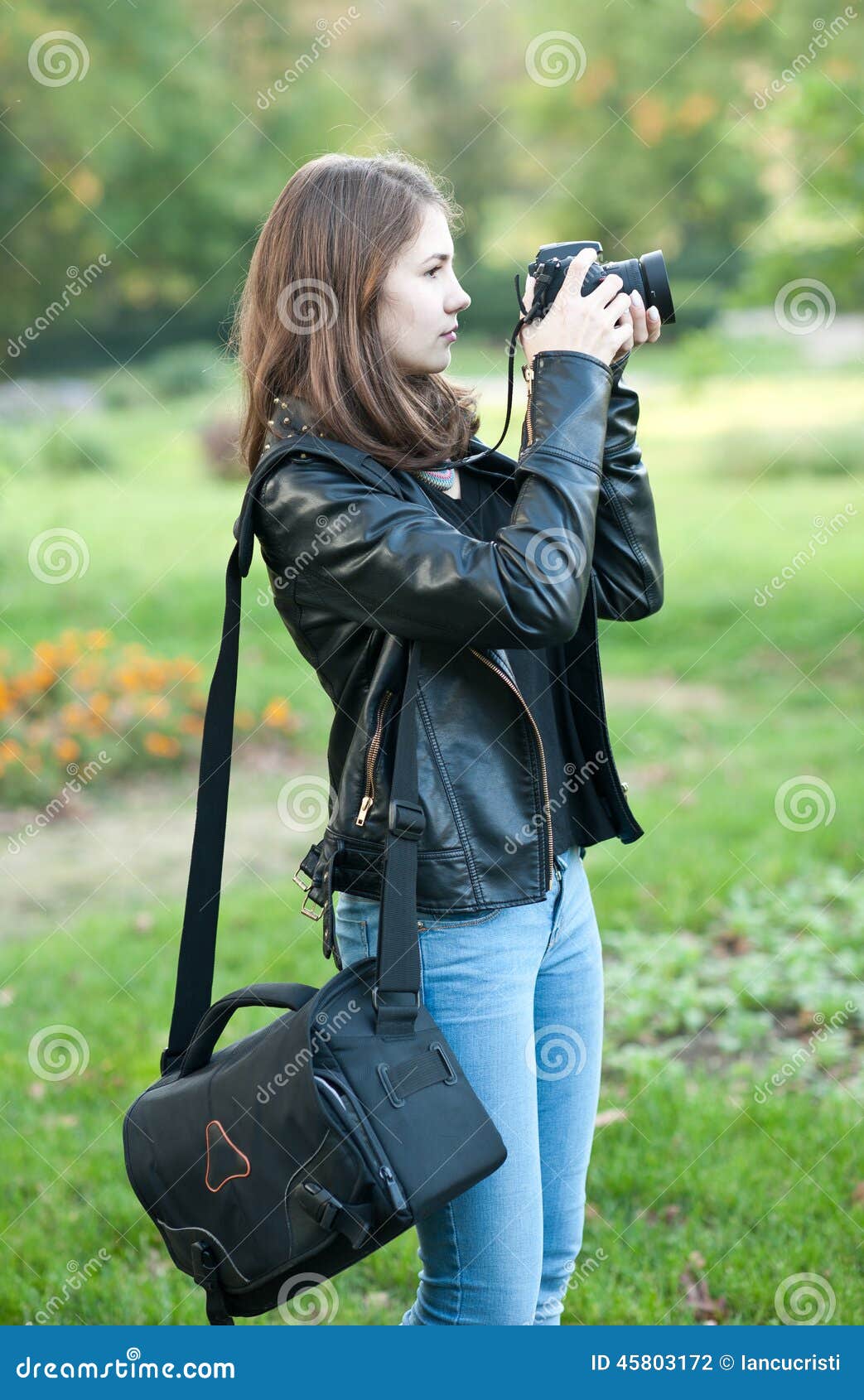 Attractive Young Girl Taking Pictures Outdoors. Cute 