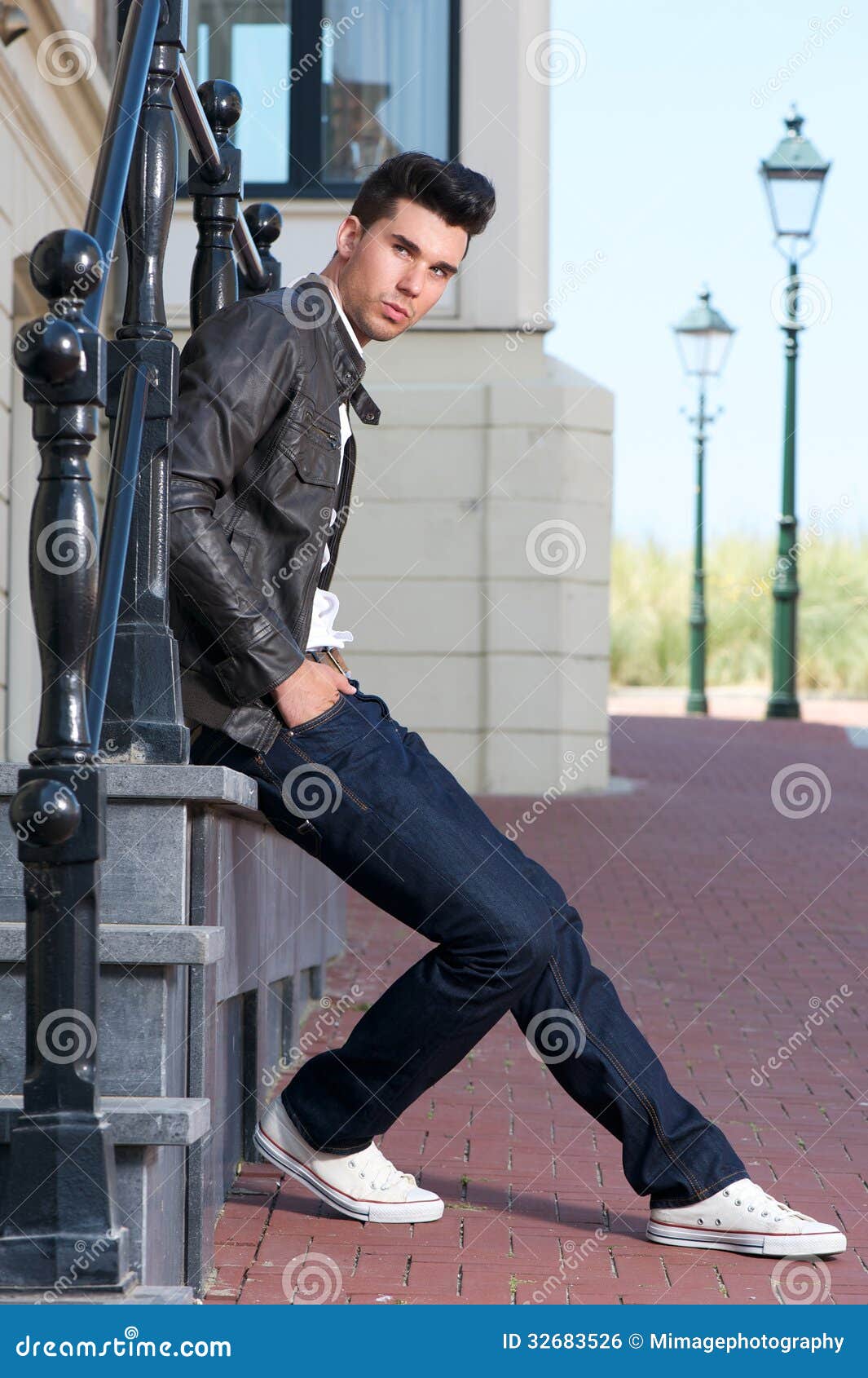 Attractive Young Man in Black Leather Jacket Sitting Outdoors Stock ...