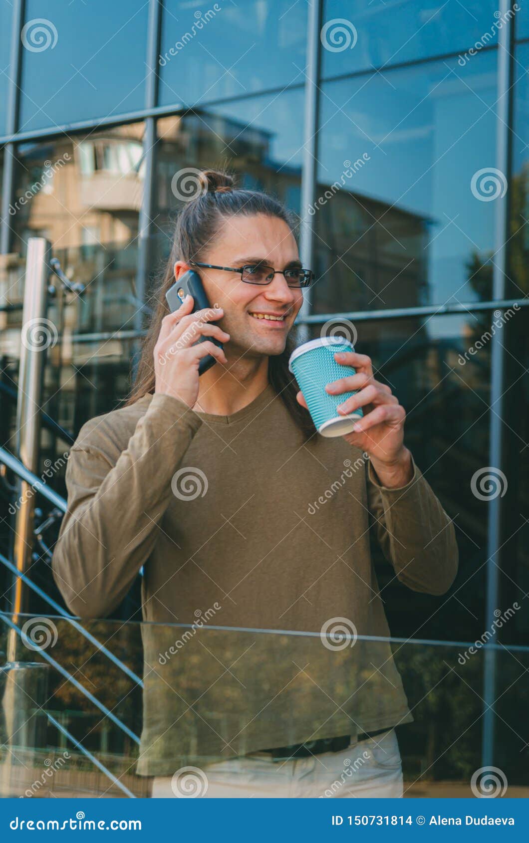 Attractive Young Man Hipster is Talking on the Phone and Drinking ...