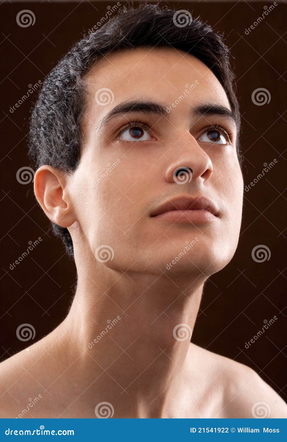 attractive young man looking upward intently
