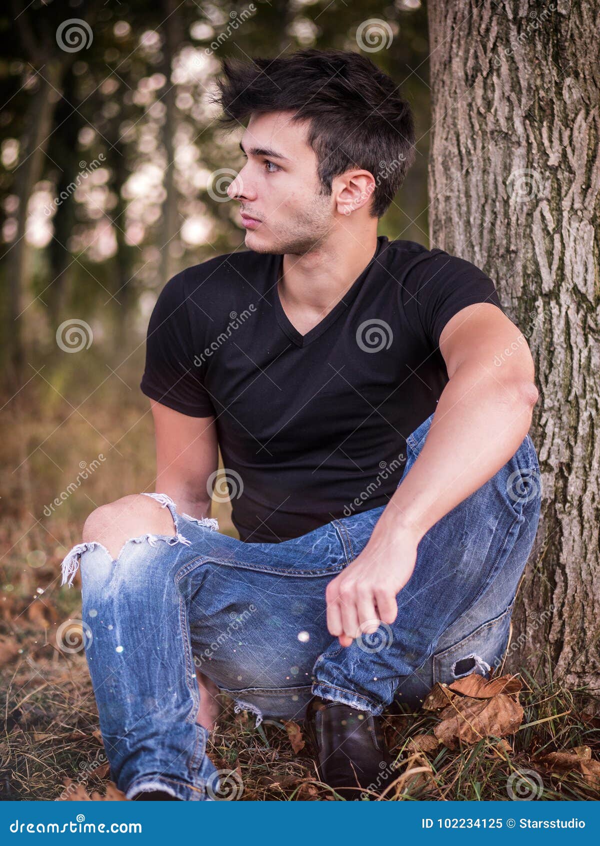 Attractive Young Man in Park Resting Against Tree Stock Image - Image ...