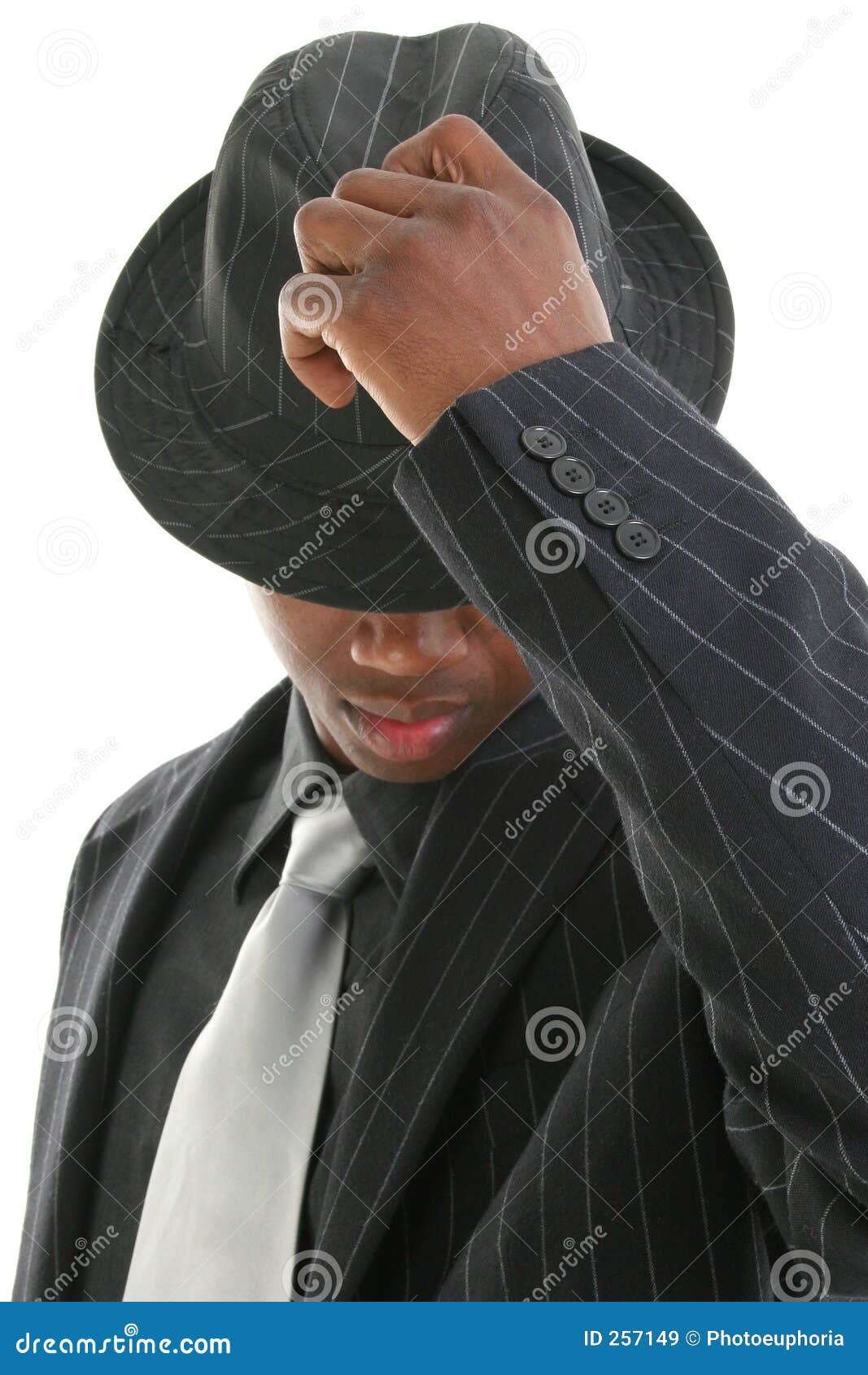 attractive young man in pinstripe suit tipping his hat